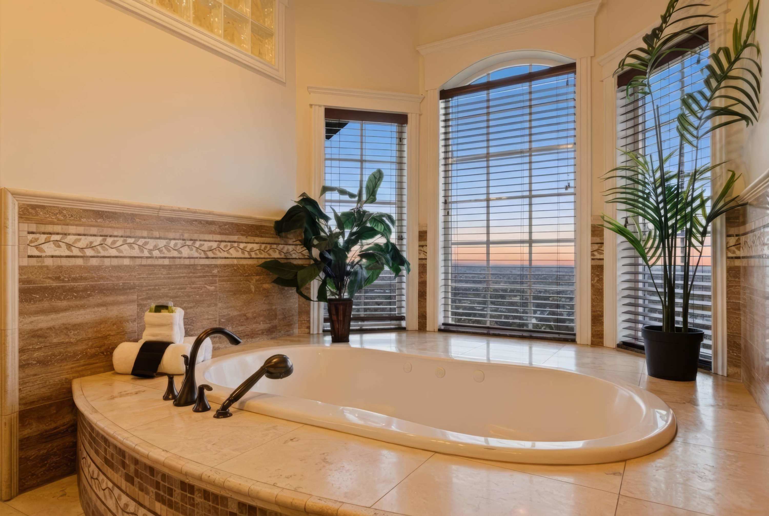 Spa-style soaking tub surrounded by windows and natural light