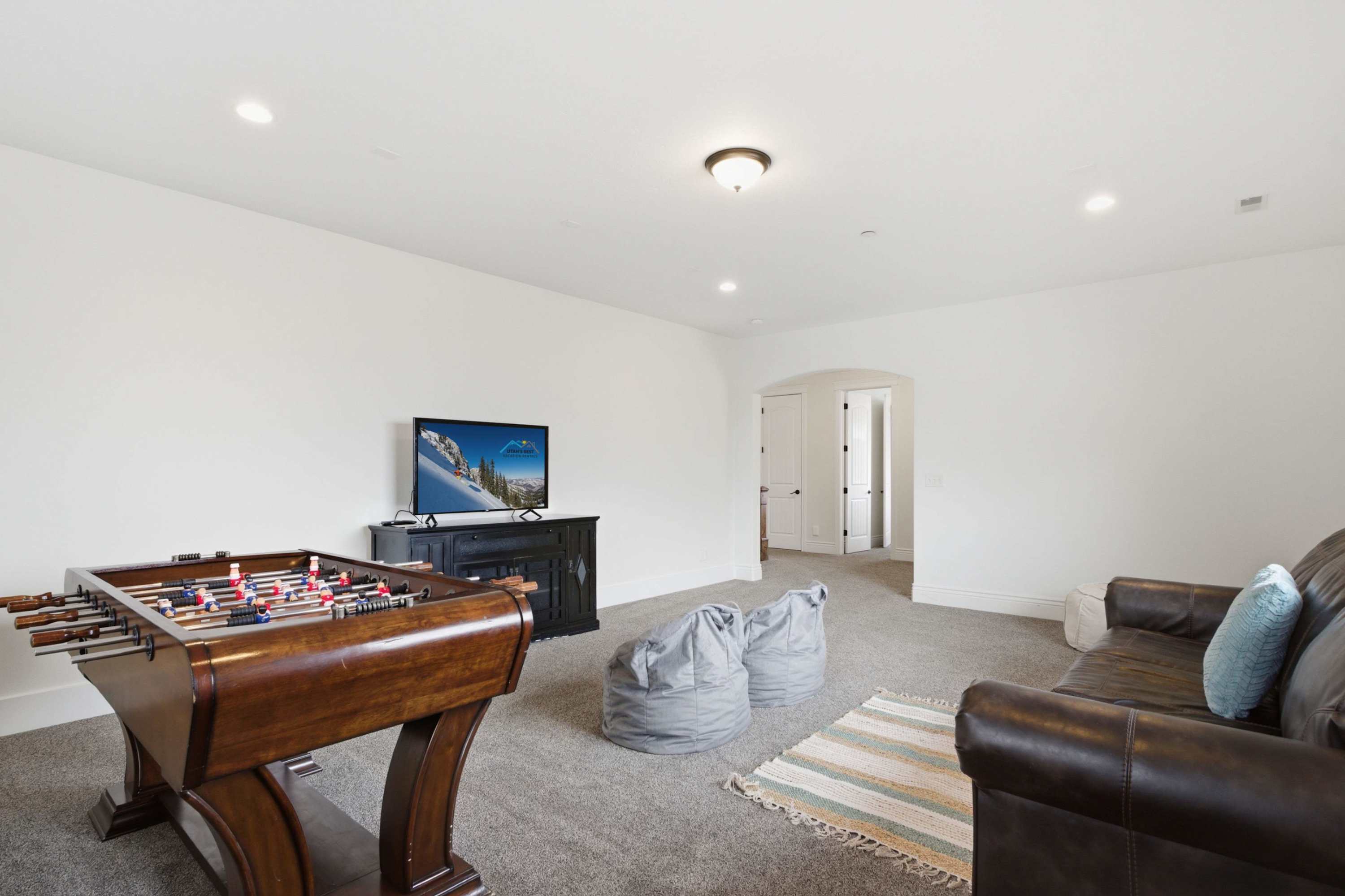 Spacious bonus room with foosball table and comfortable seating