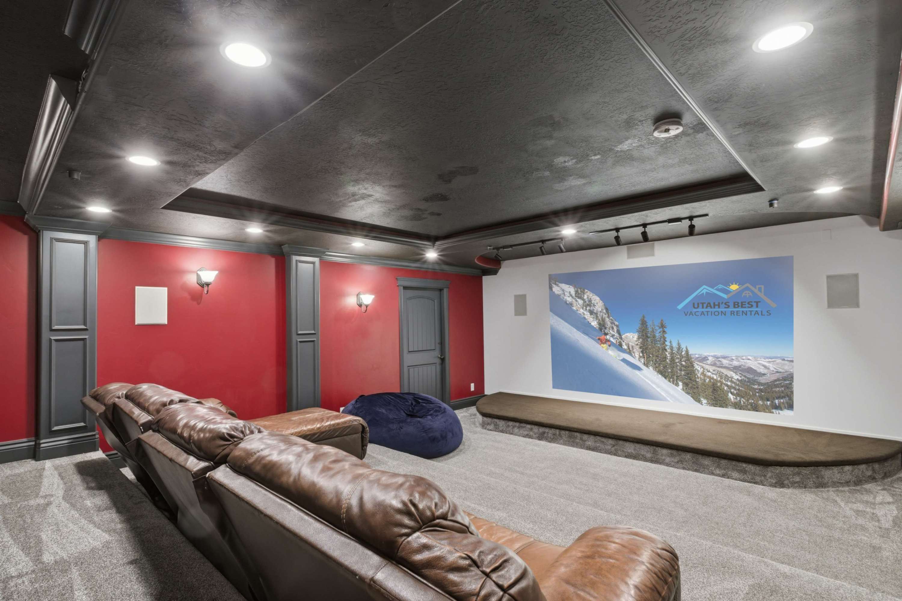 Private home theater with oversized screen and stadium seating