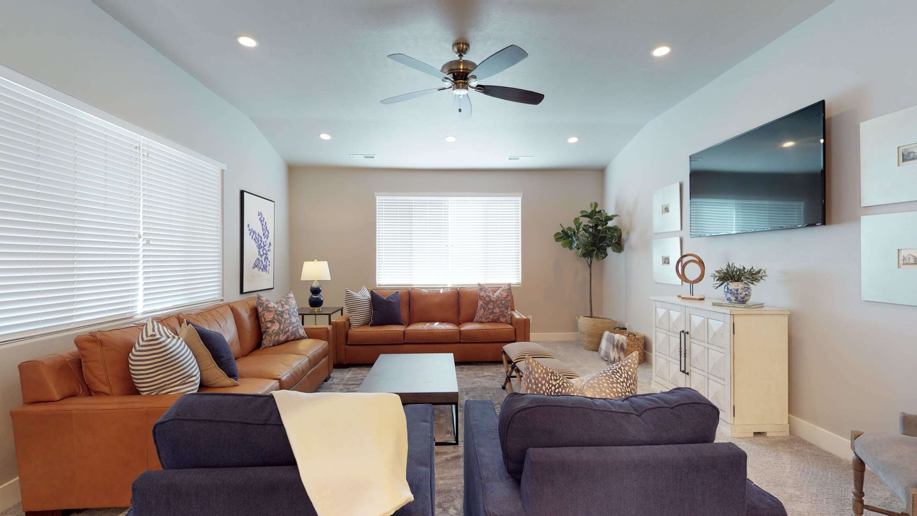 109 - Family room leather sofa seating and lounge chairs with TV