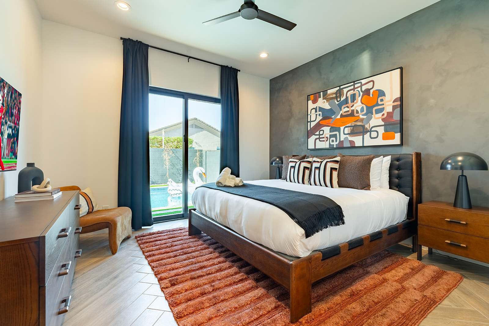 4th Bedroom offering a King bed, designer furnishings, smart TV, custom accent wall, closet space, and a jack and jill style en-suite bathroom.