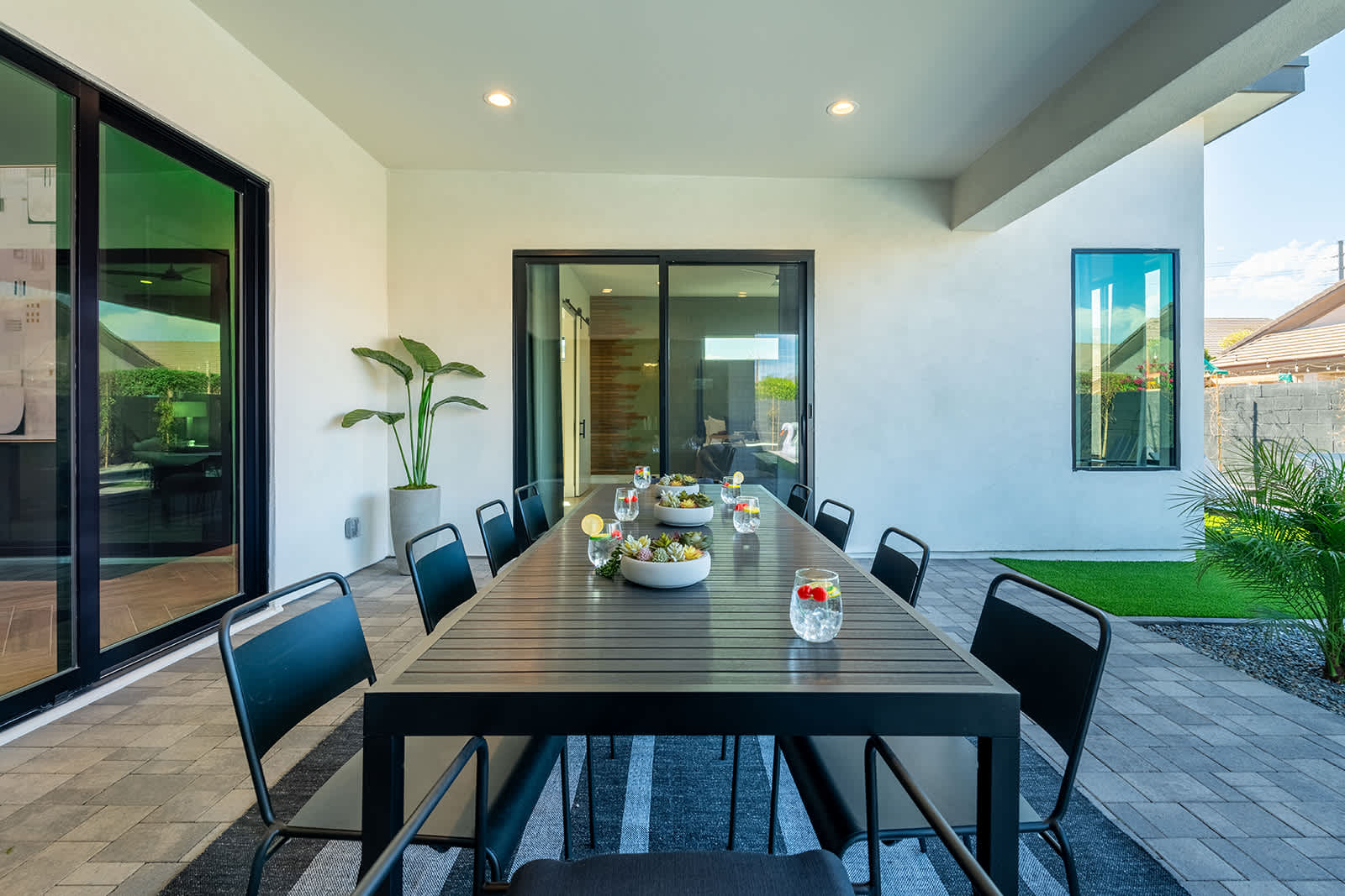 This stunning private yard features a sparkling pool, covered outdoor dining area, sun loungers, lawn space, built-in fire pit & BBQ Grill!