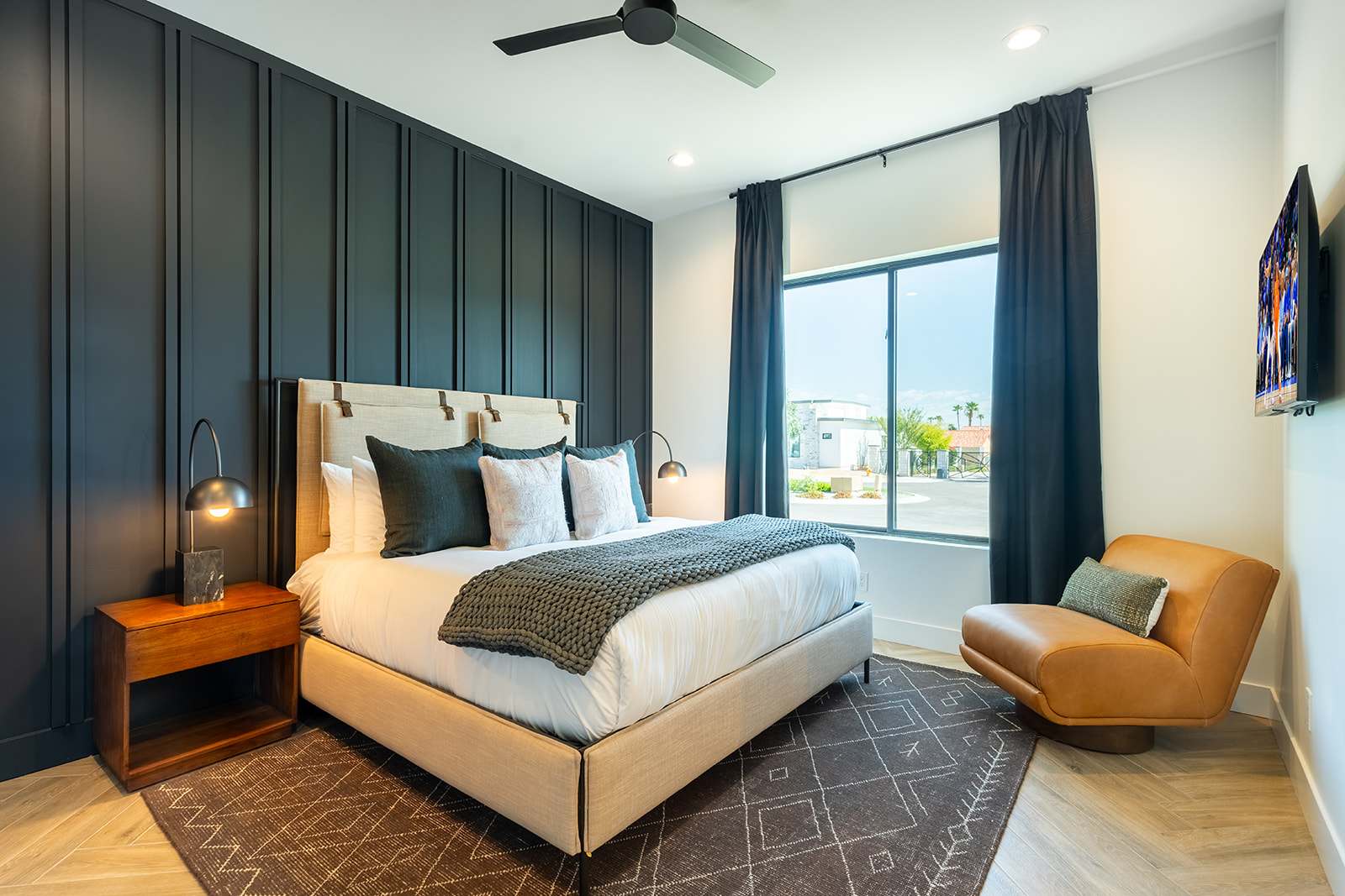 3rd bedroom featuring a King-sized bed, smart TV, designer furnishings, walk-in closet, en-suite bathroom, and custom accent wall.