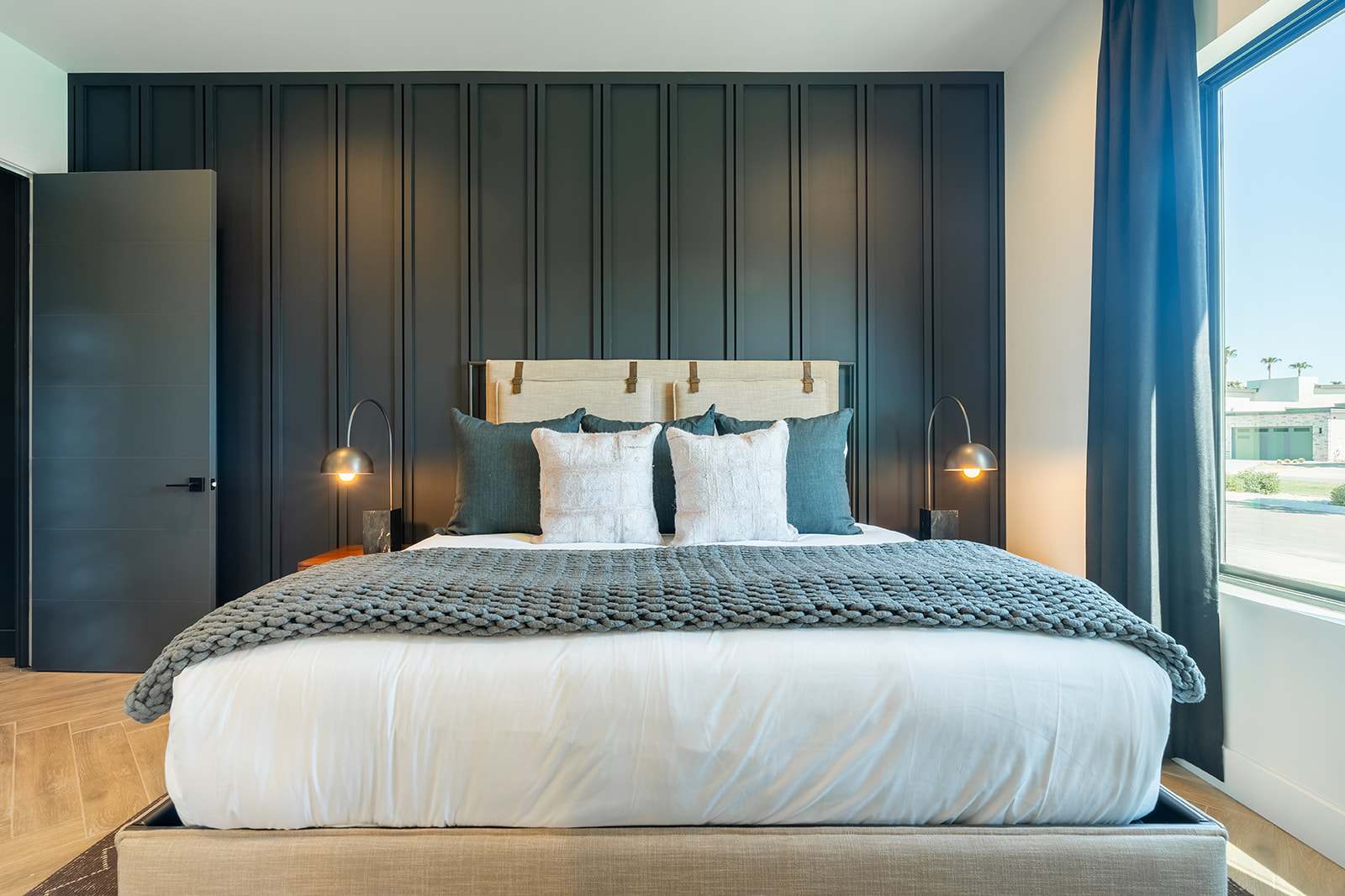 3rd bedroom featuring a King-sized bed, smart TV, designer furnishings, walk-in closet, en-suite bathroom, and custom accent wall.