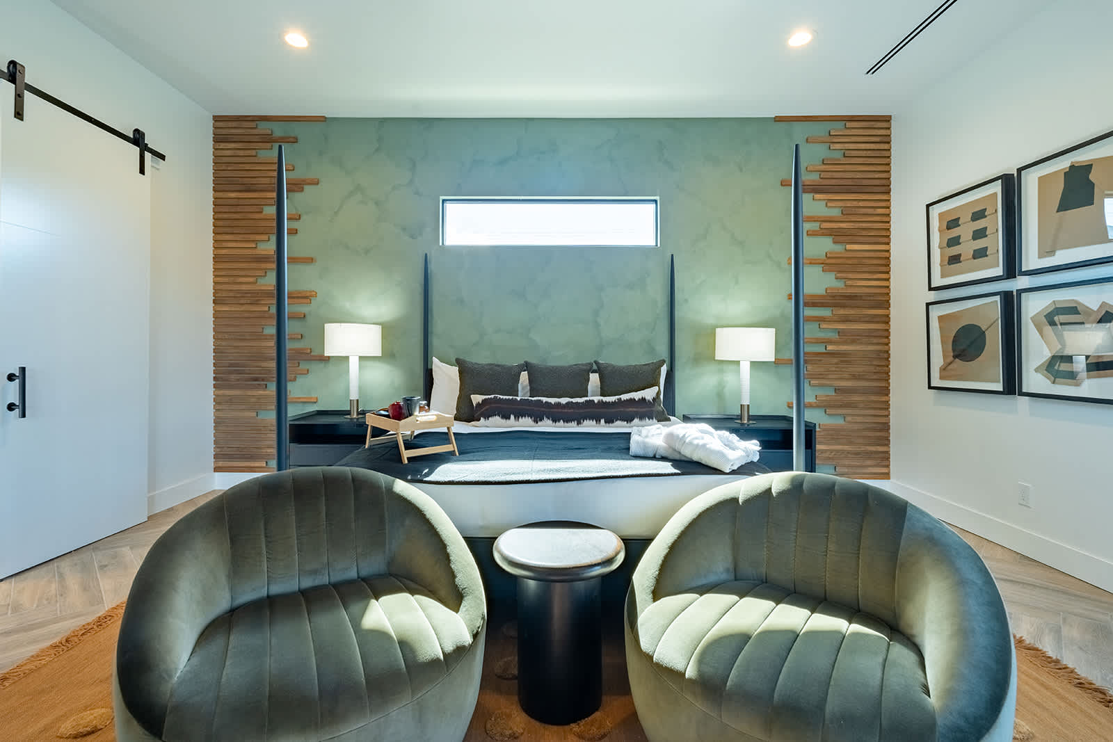 The modern dining area features a striking black wooden dinner table and seating for 6 in it's comfortable padded chairs.