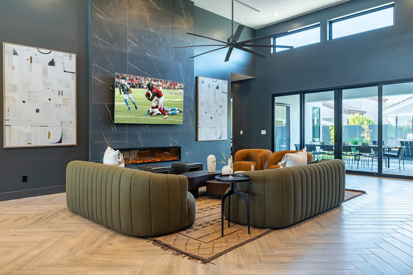 Unwind in this spacious living area with designer furnishings, a large Smart TV, an electric fireplace, and an open layout perfect for relaxation or game day.