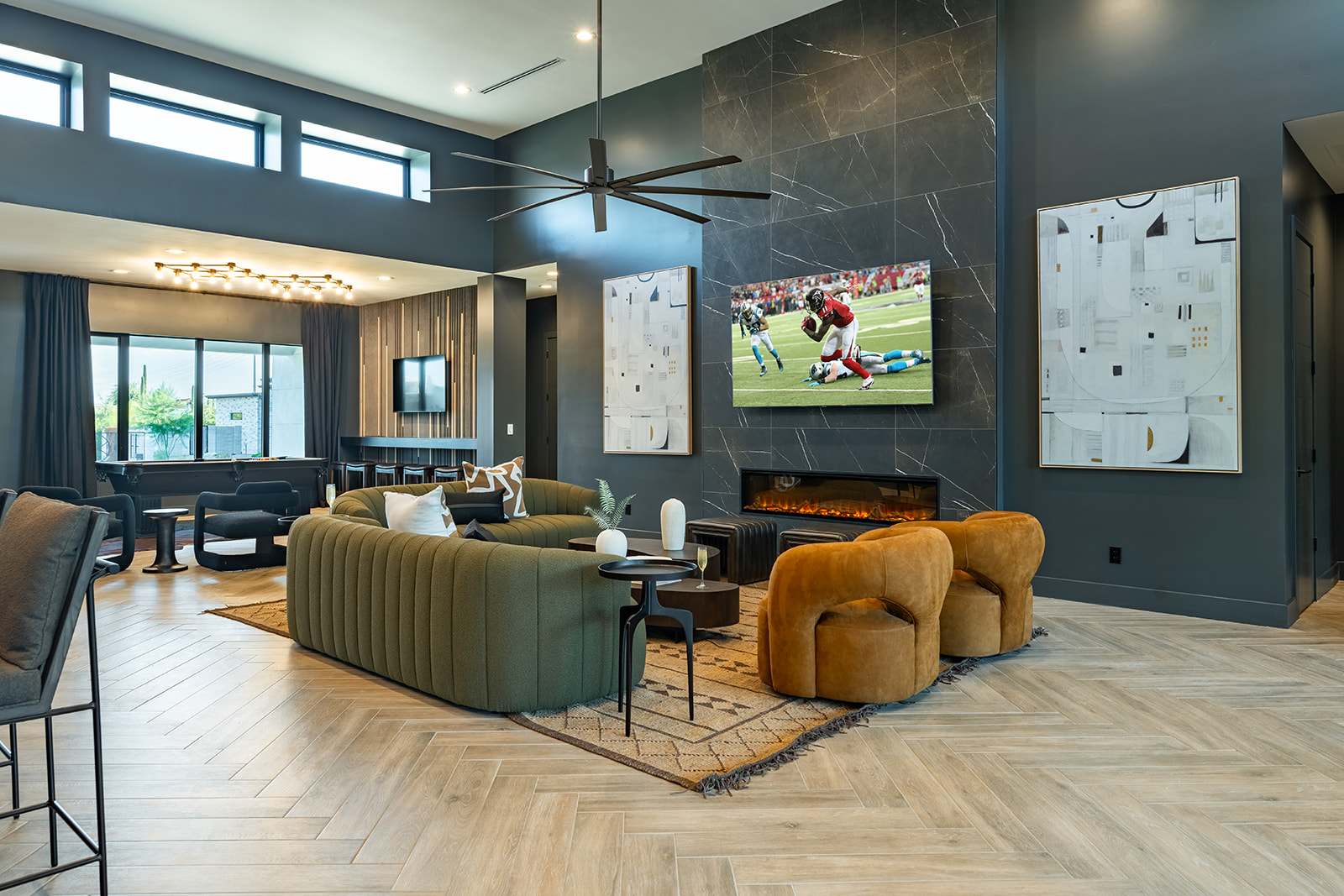 Unwind in this spacious living area with designer furnishings, a large Smart TV, an electric fireplace, and an open layout perfect for relaxation or game day.