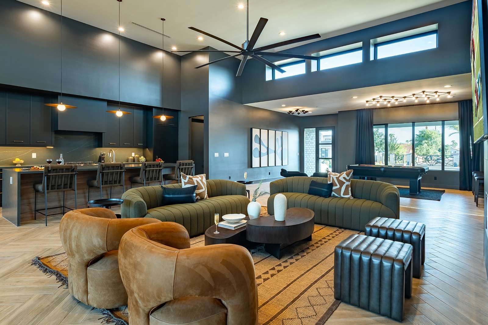 Unwind in this spacious living area with designer furnishings, a large Smart TV, an electric fireplace, and an open layout perfect for relaxation or game day.