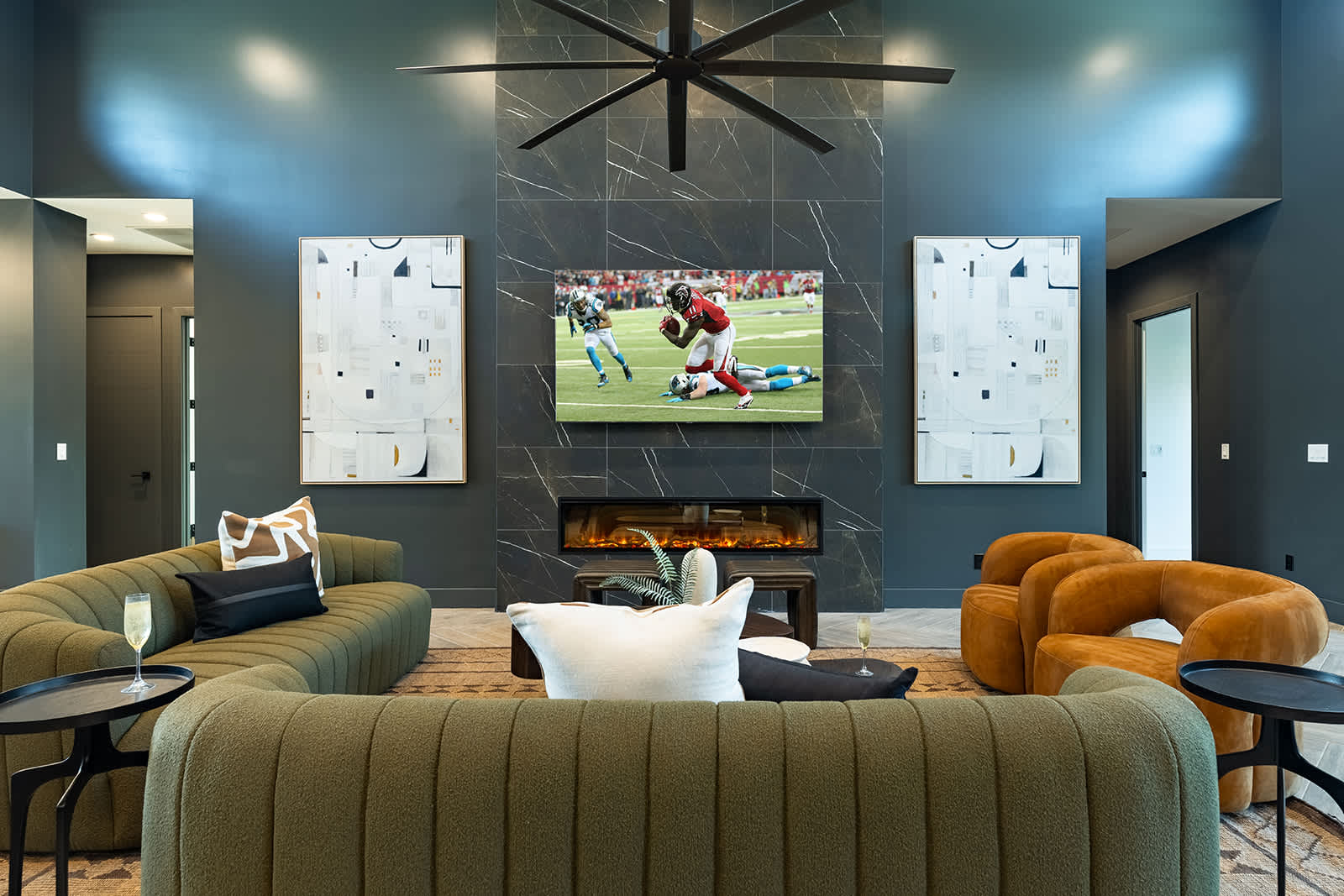Unwind in this spacious living area with designer furnishings, a large Smart TV, an electric fireplace, and an open layout perfect for relaxation or game day.