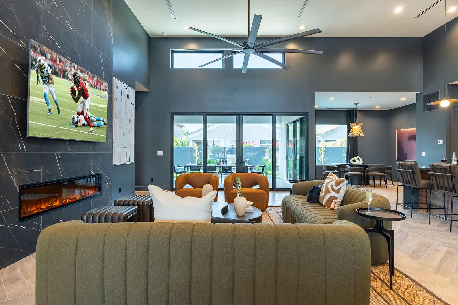 Unwind in this spacious living area with designer furnishings, a large Smart TV, an electric fireplace, and an open layout perfect for relaxation or game day.