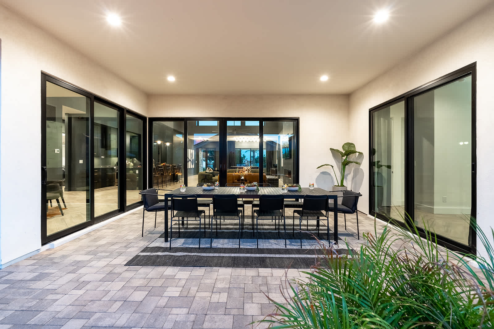 This stunning private yard features a sparkling pool, covered outdoor dining area, sun loungers, lawn space, built-in fire pit & BBQ Grill!