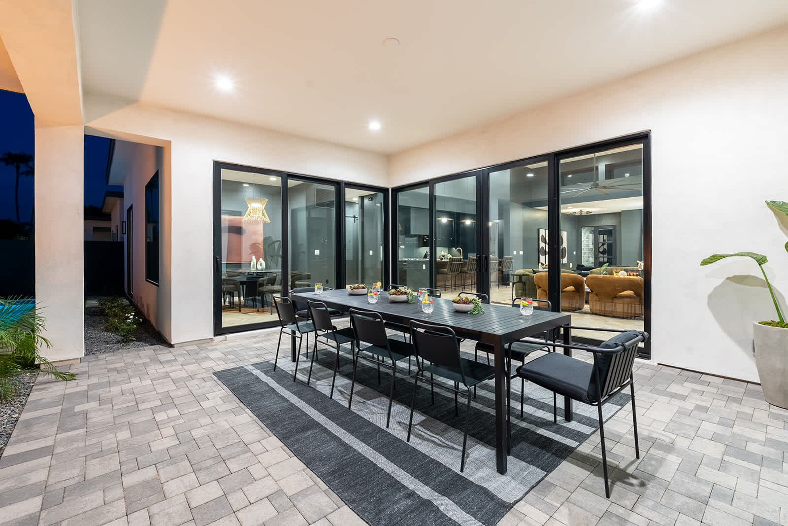 This stunning private yard features a sparkling pool, covered outdoor dining area, sun loungers, lawn space, built-in fire pit & BBQ Grill!