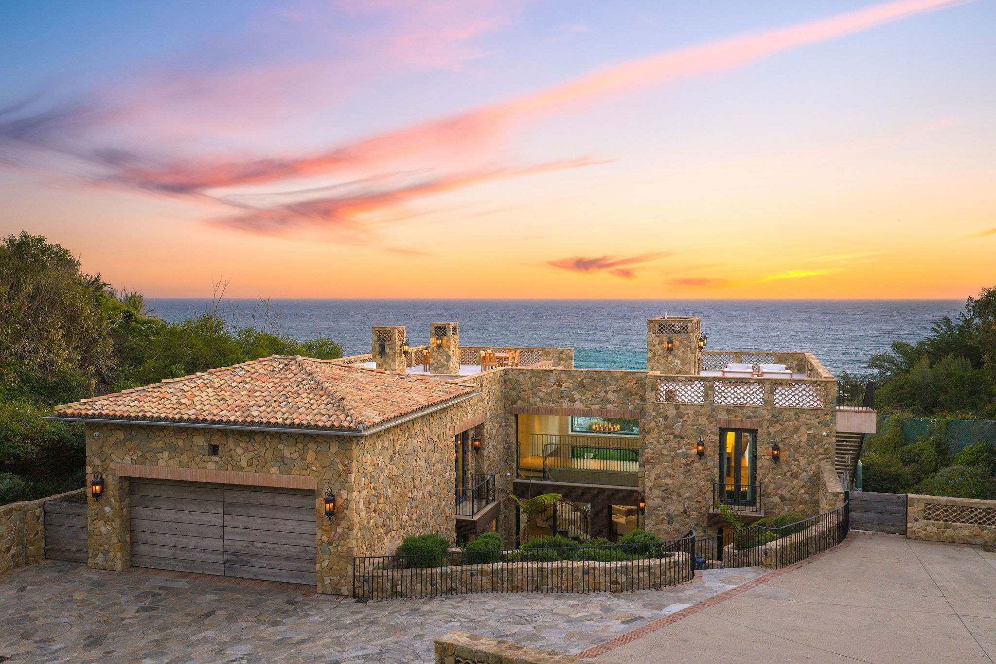 Mediterranean-inspired stone villa overlooking the Pacific Ocean in Malibu.