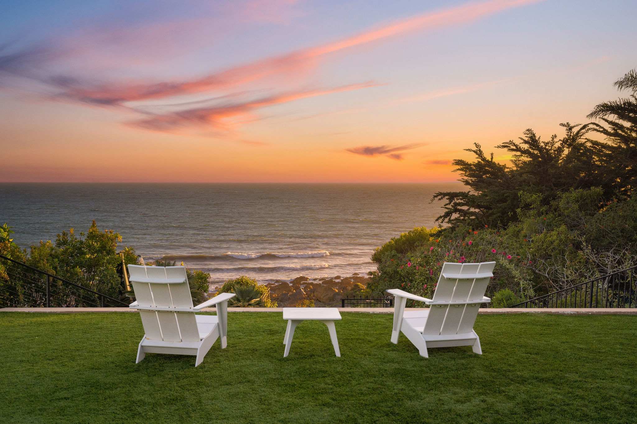 Adirondack chairs overlooking Malibu’s rocky coastline.