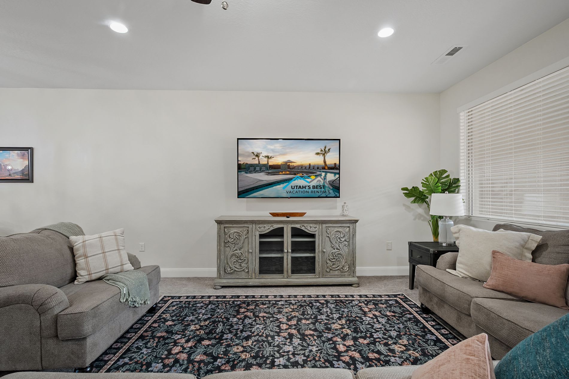 Cozy entertainment space featuring large TV and stylish furnishings