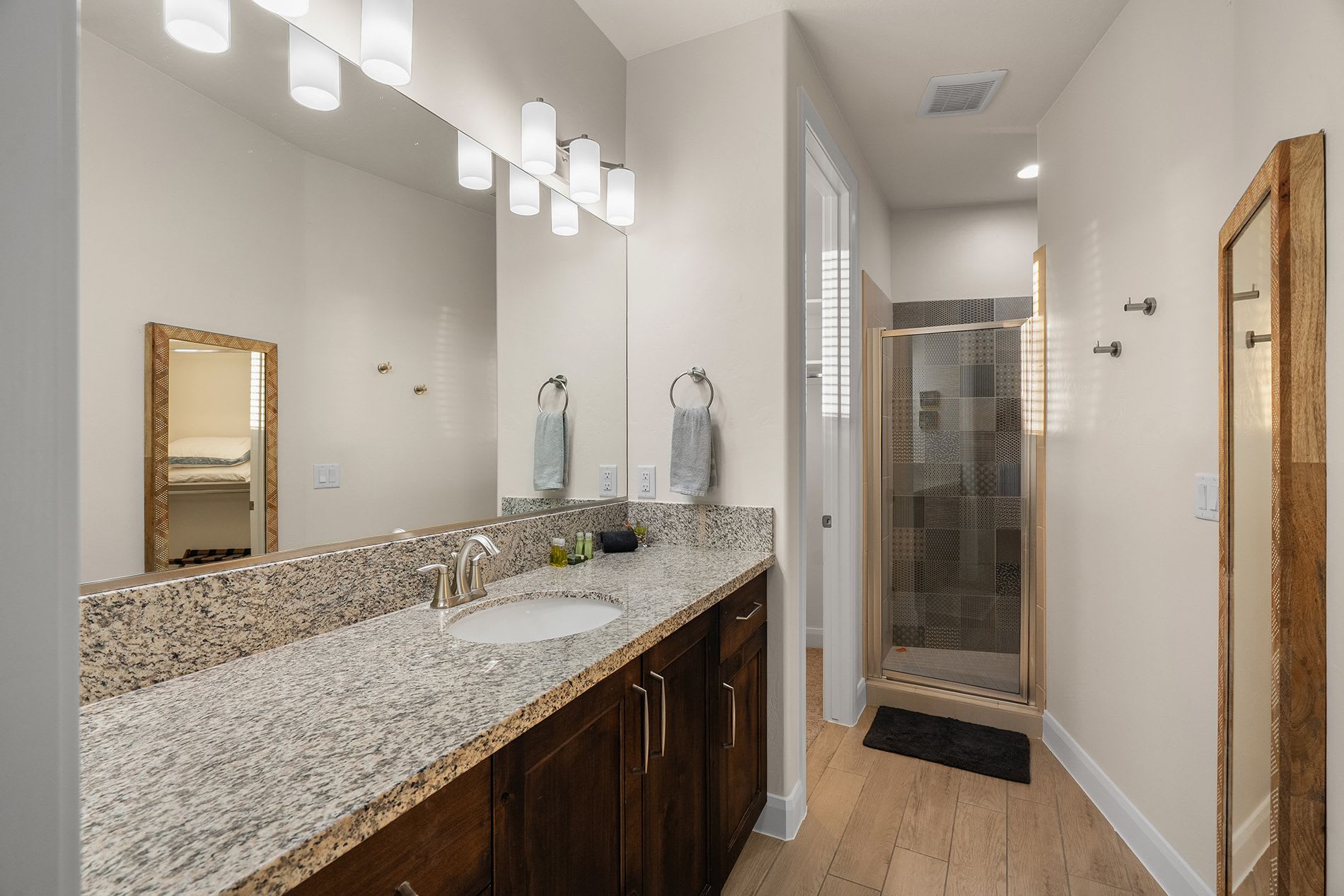 Elegant bathroom with granite countertops and modern lighting