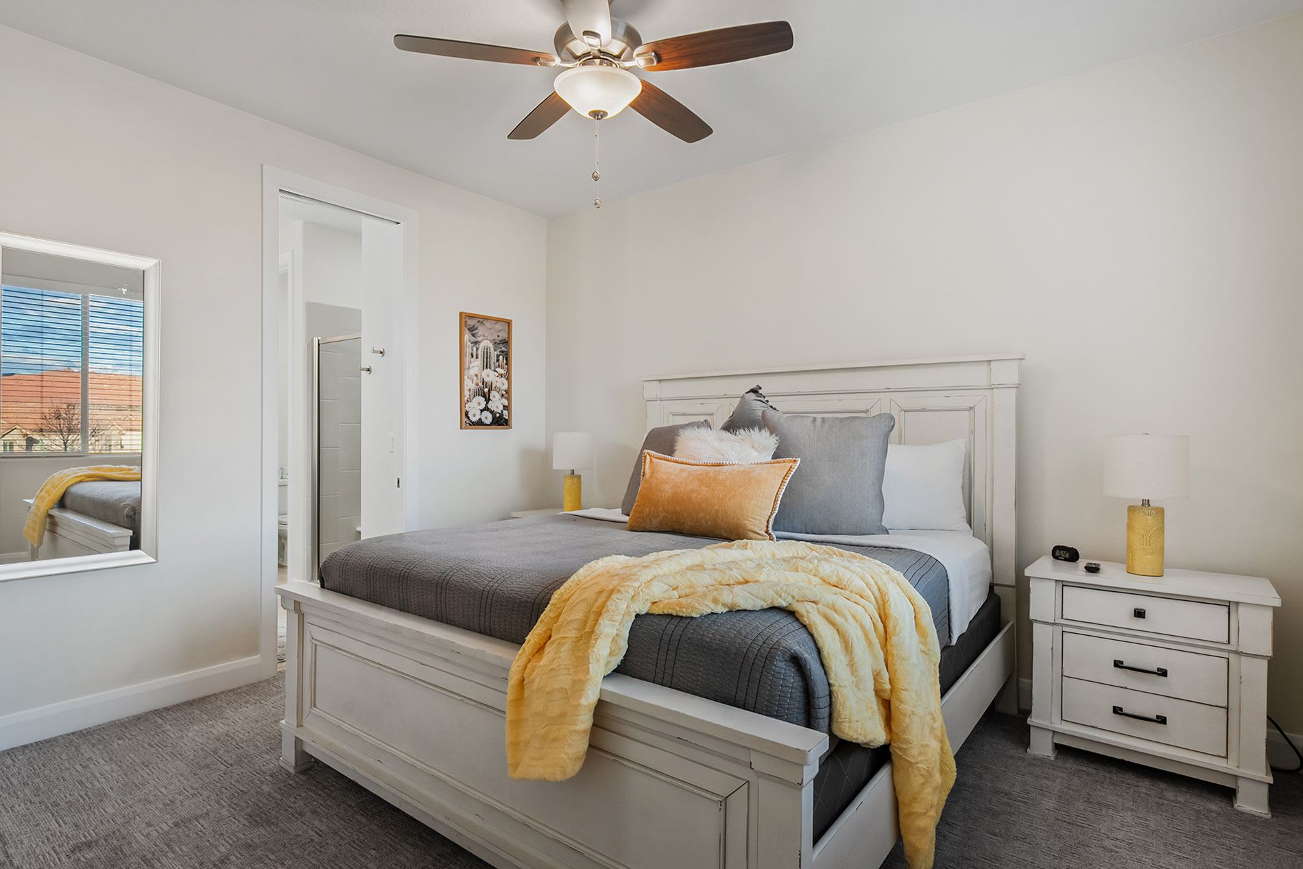 Cozy bedroom with bright natural light and neighborhood views