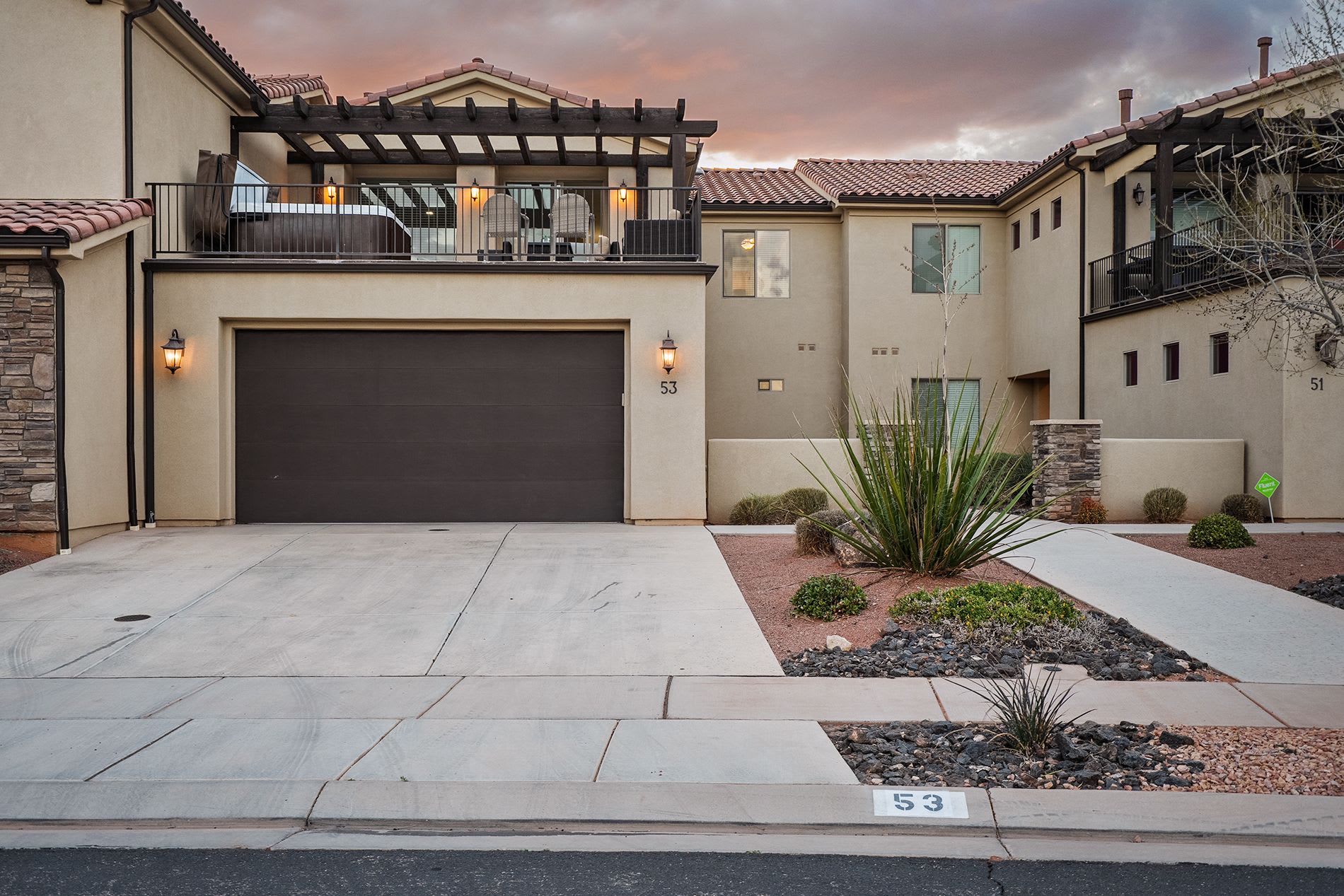 Exterior view of the home with garage and desert landscaping