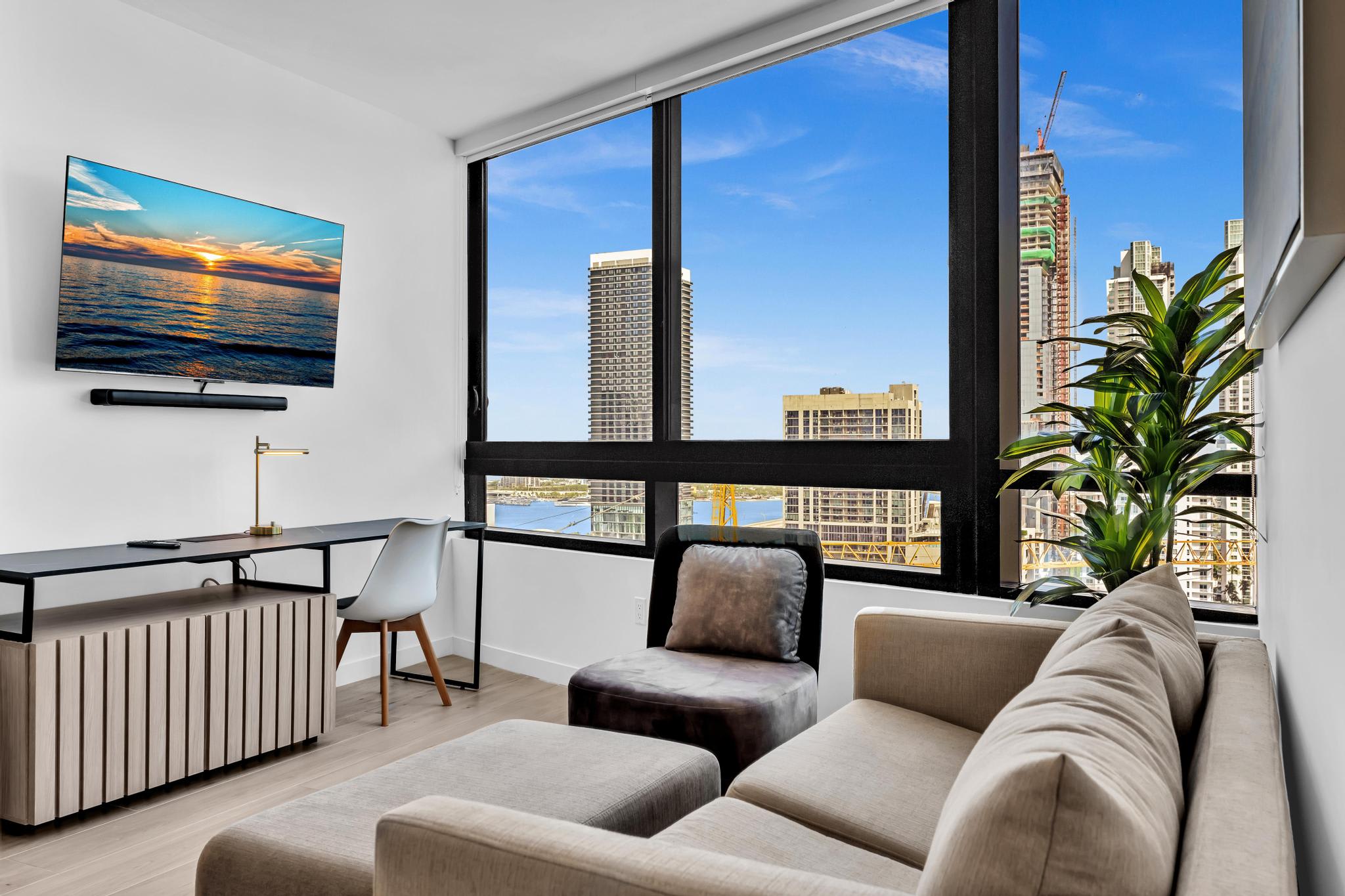 Relax in this chic living space with breathtaking city views and a stylish workspace.