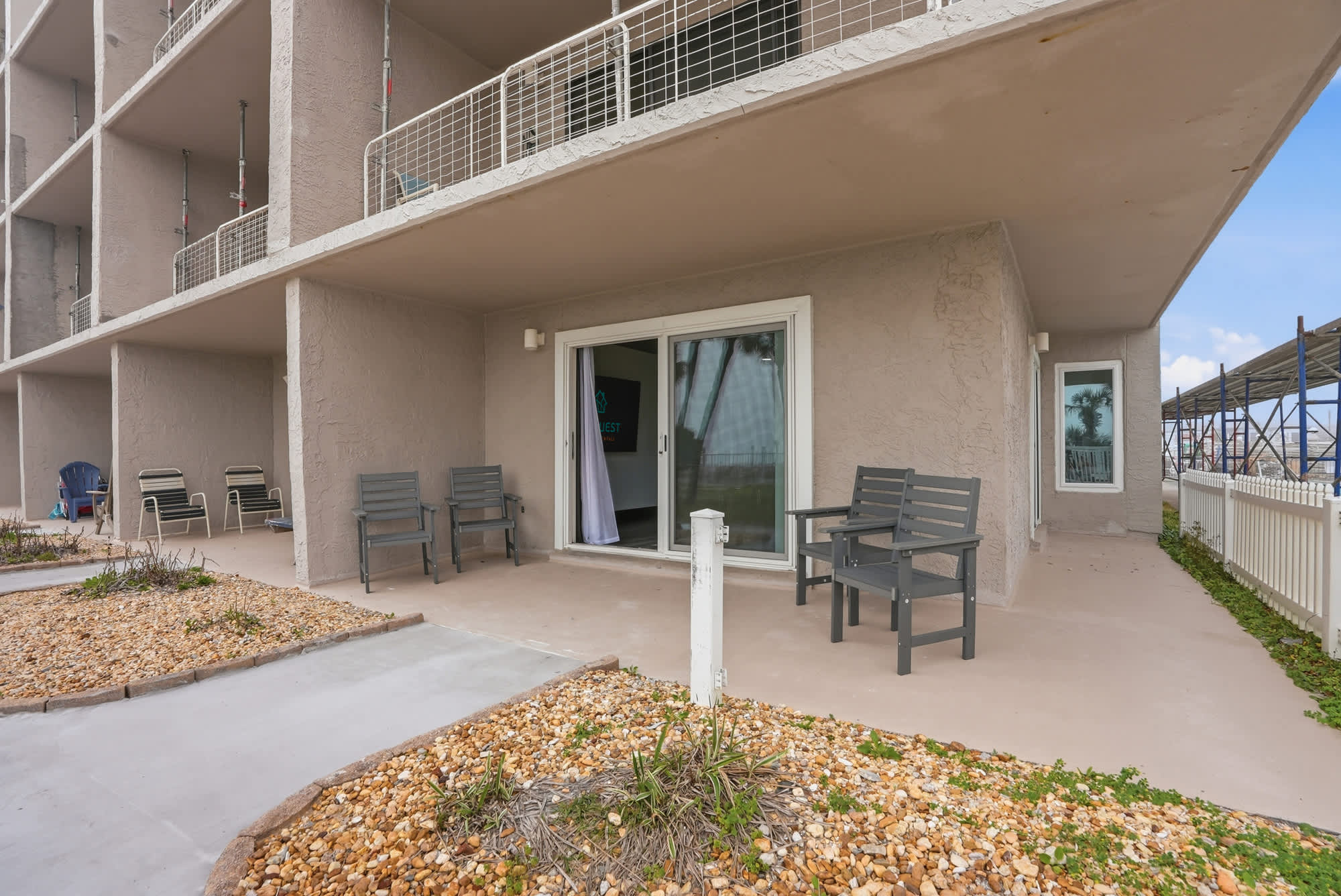The Summit 132 – Patio with seating, sliding glass door, and view of landscaped area.