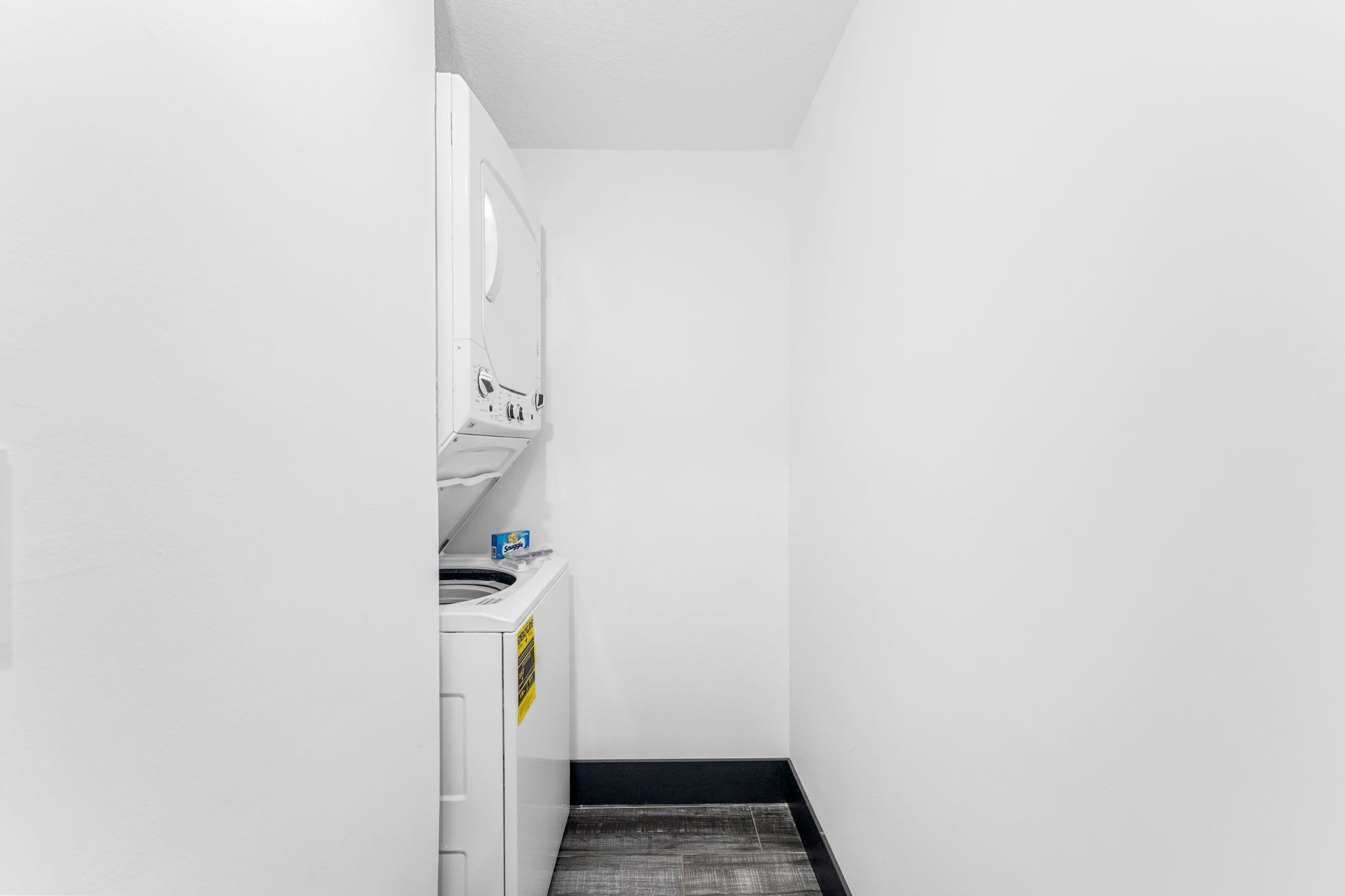 The Summit 132 – Laundry area with stacked washer and dryer against a plain white wall.