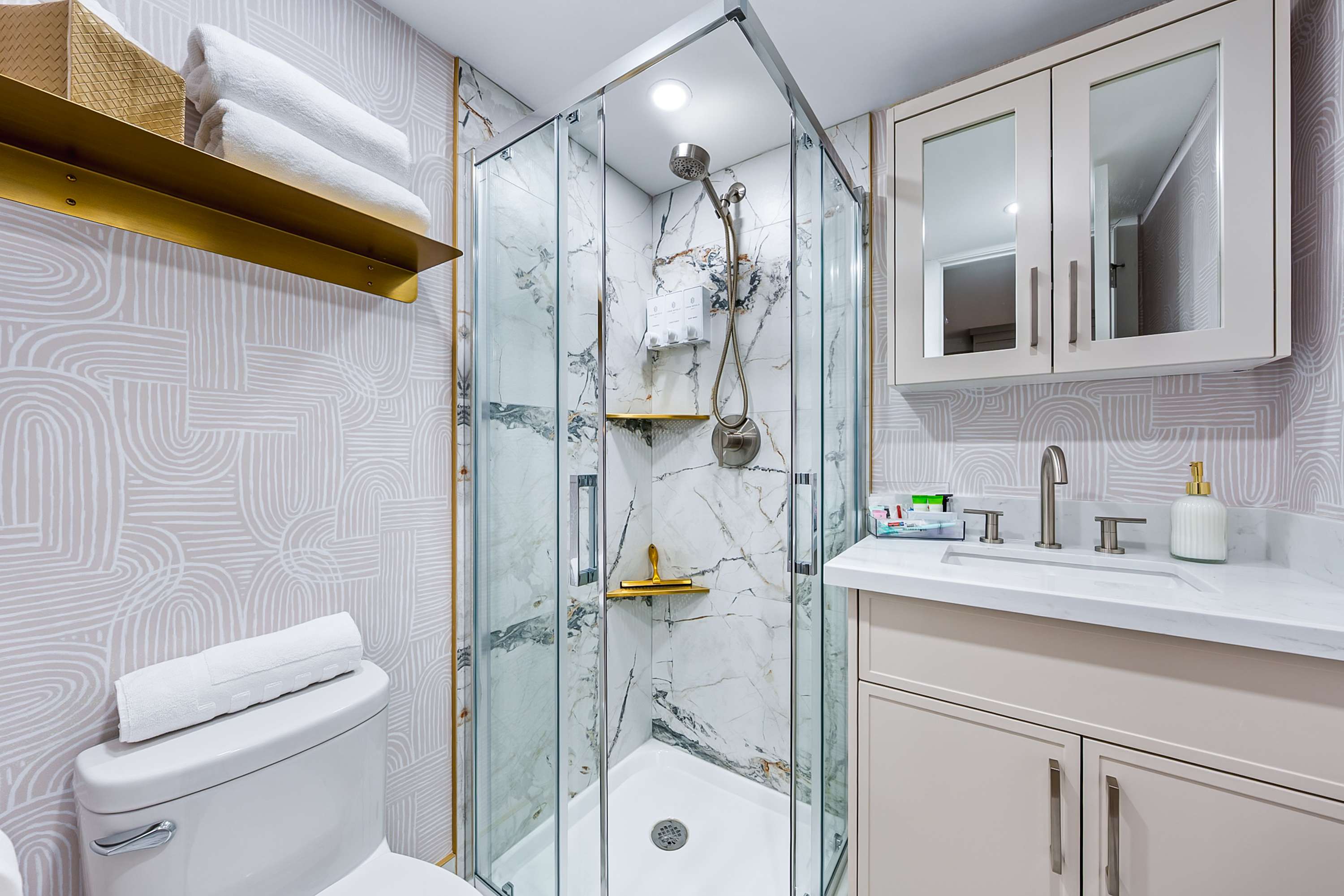 Fresh and well-appointed modern bathroom with glass standing shower.