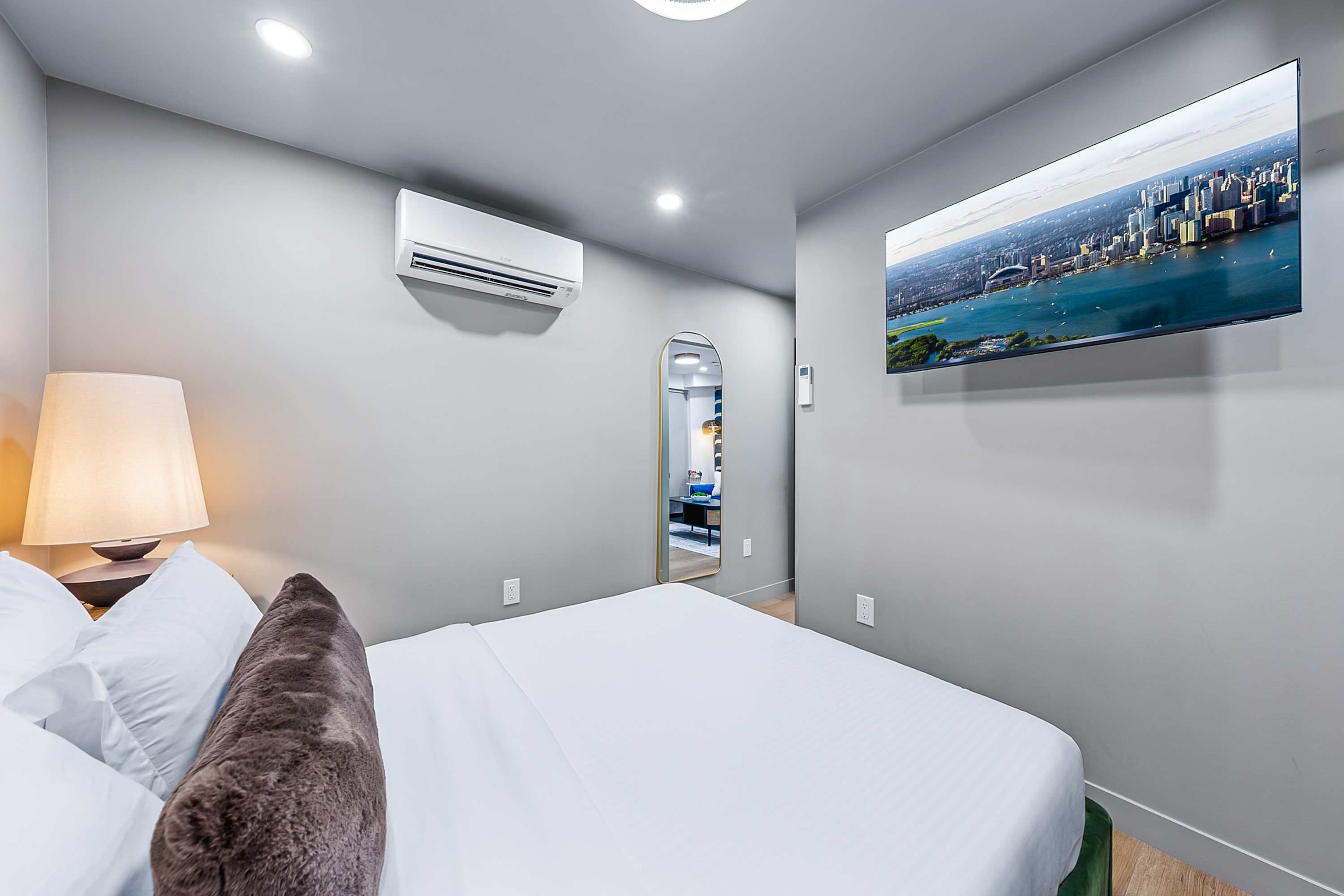 A serene bedroom designed for deep rest, movie nights and relaxation with an A/C.