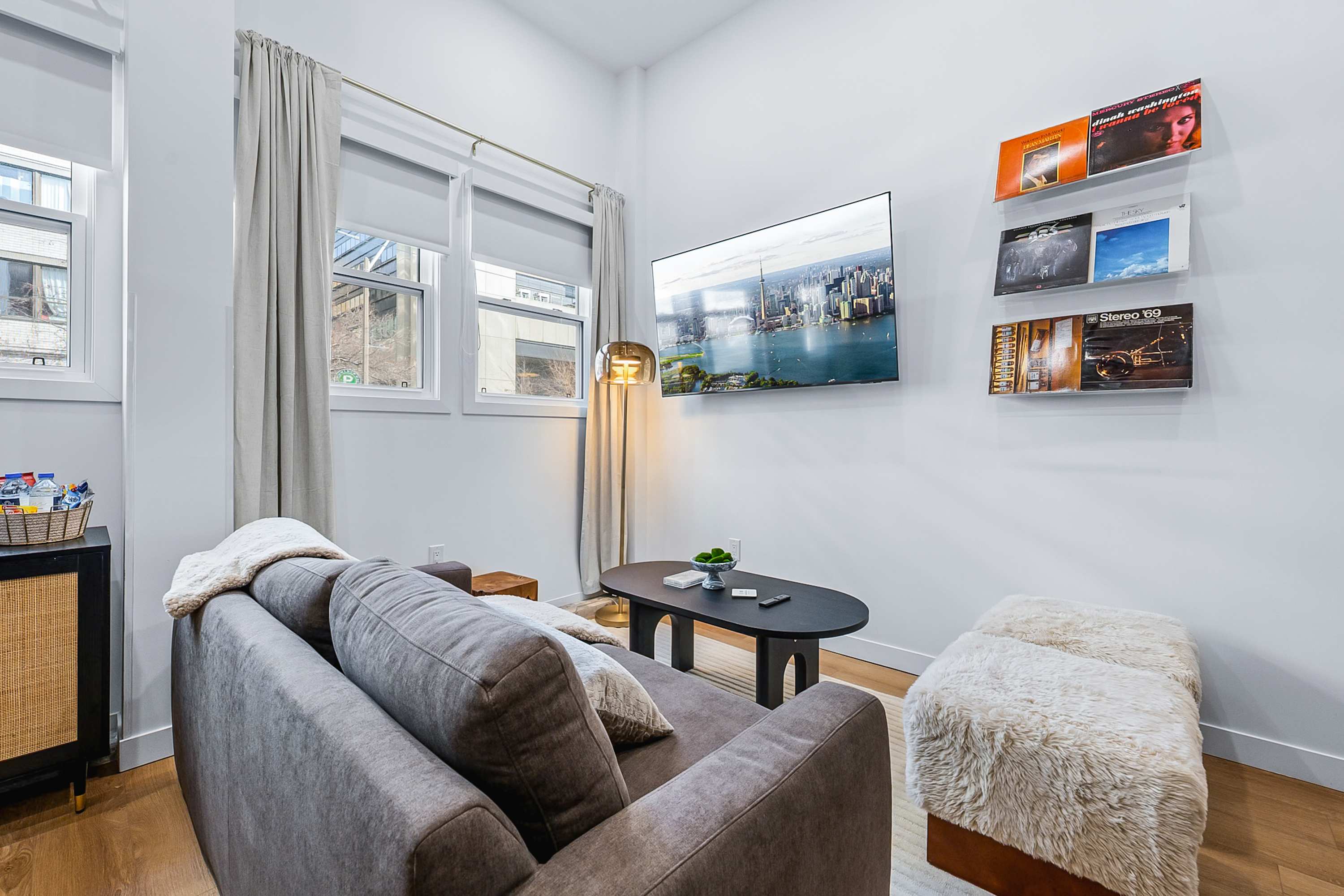 Cozy lounge with sofa, smart TV and modern décor.