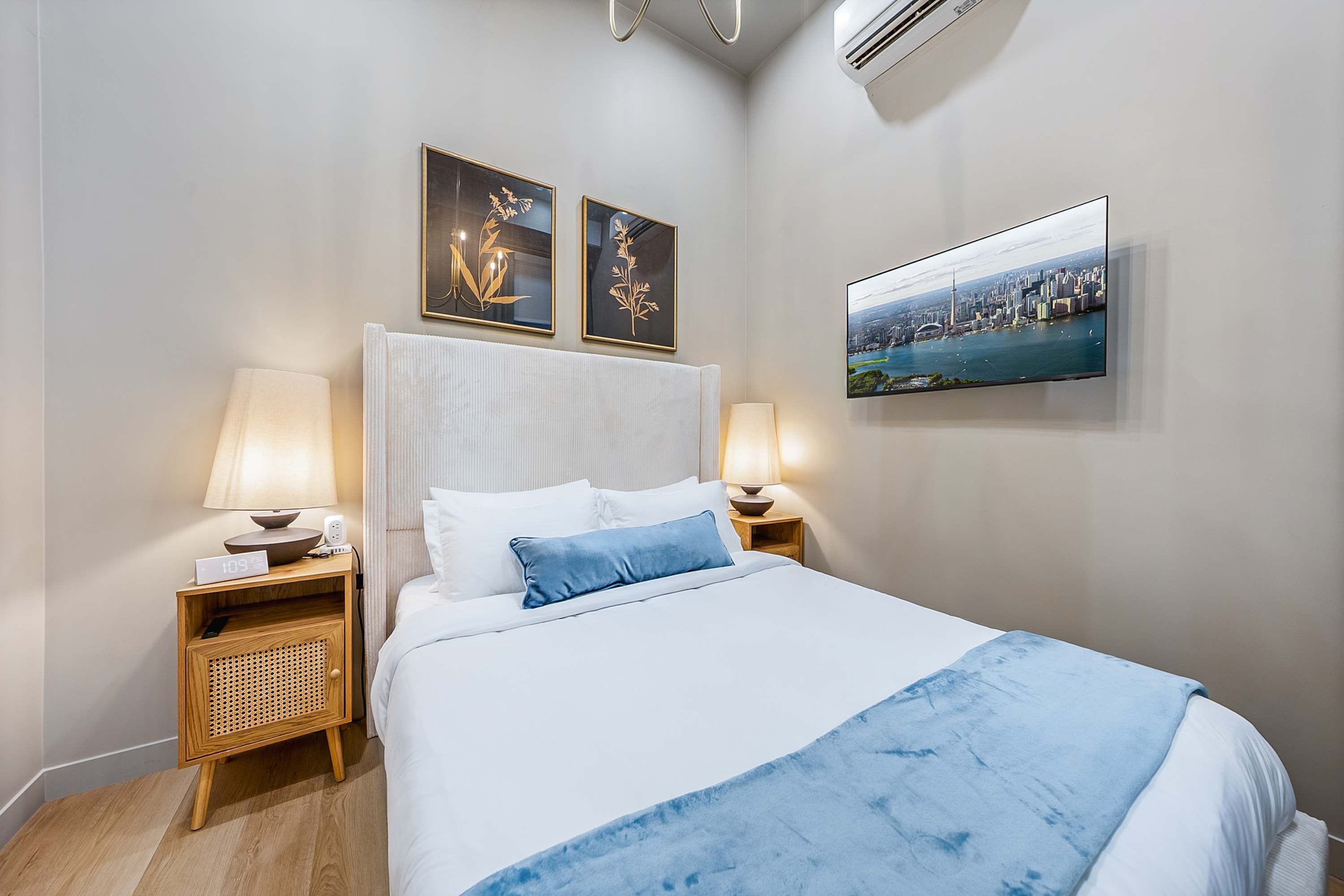 Serene bedroom with a plush queen bed and a smart TV.