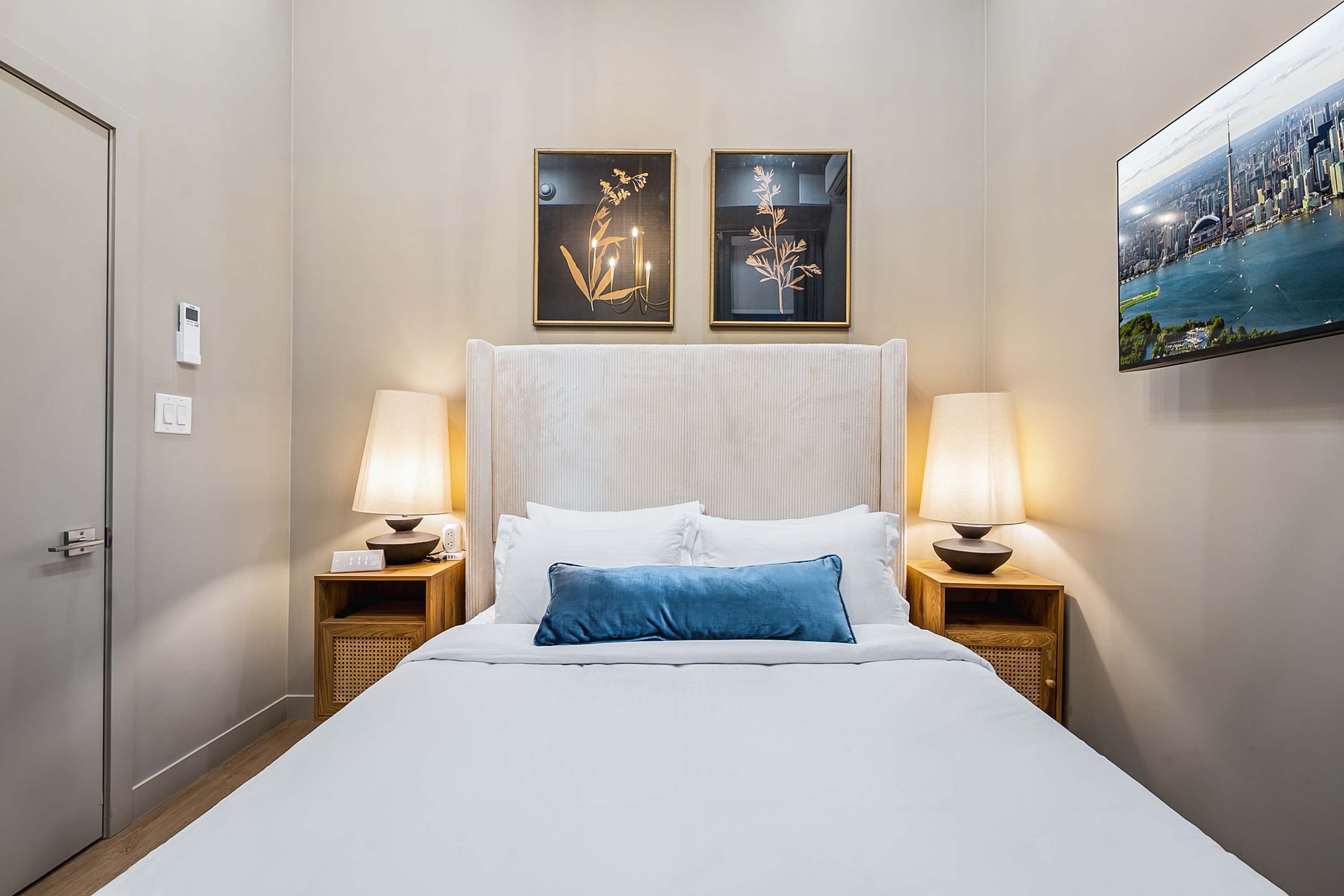 Serene bedroom with a plush queen bed and a smart TV.