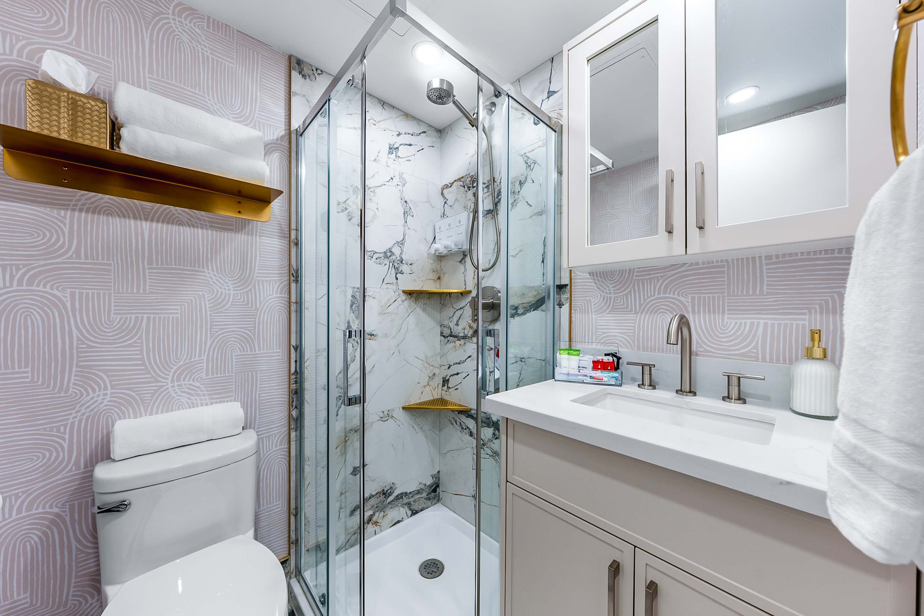 Modern bathroom with a walk-in glass shower.