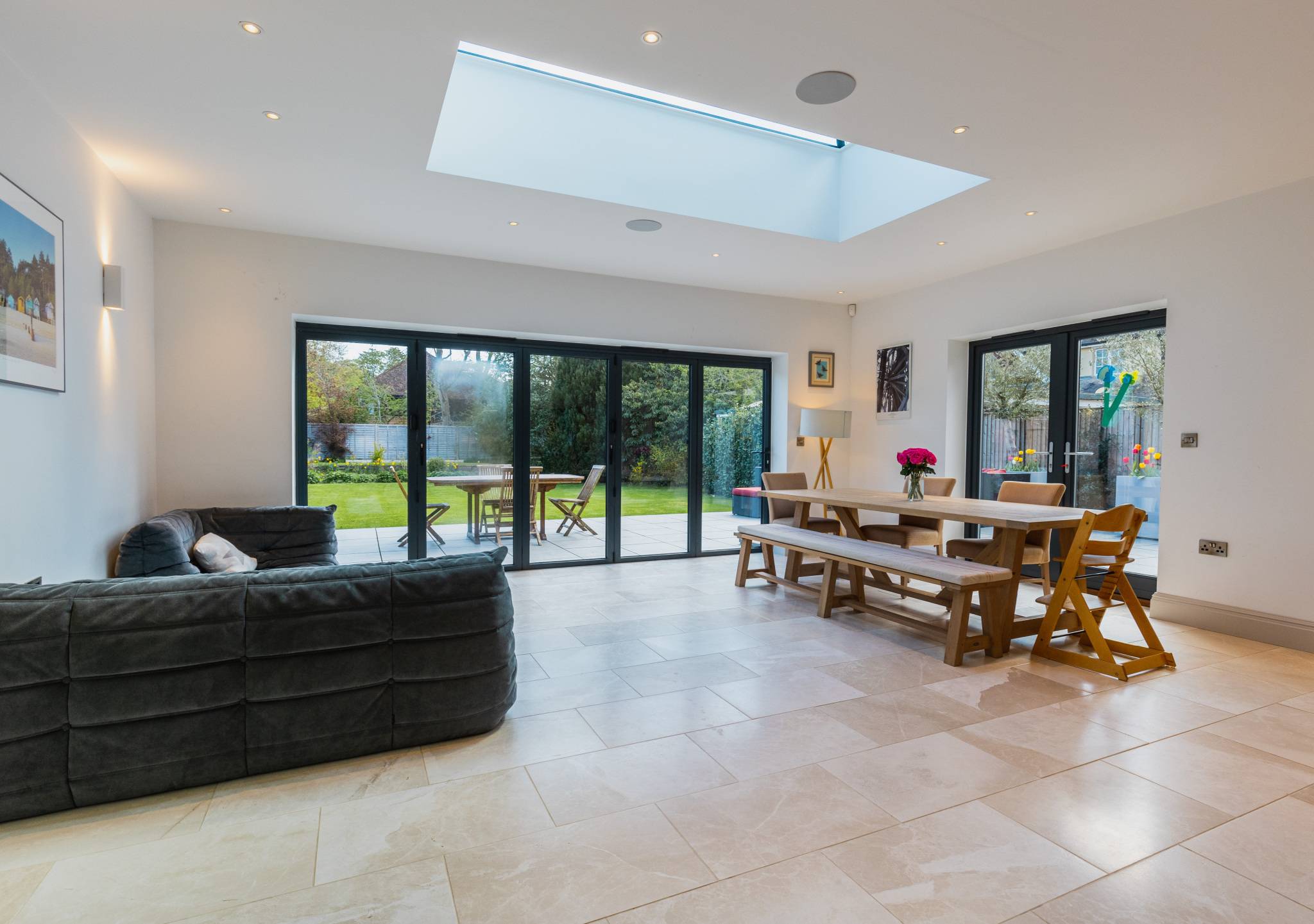 Bright open-plan kitchen, dining and lounge with bi-fold doors that lead to the garden.