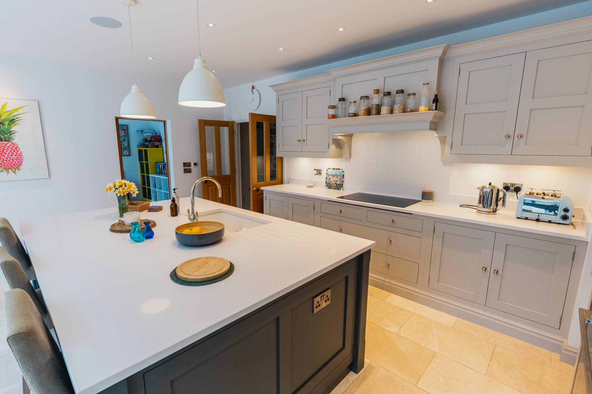 Stylish fully equipped kitchen with large island, pendant lighting and modern appliances, ideal for cooking and socialising.