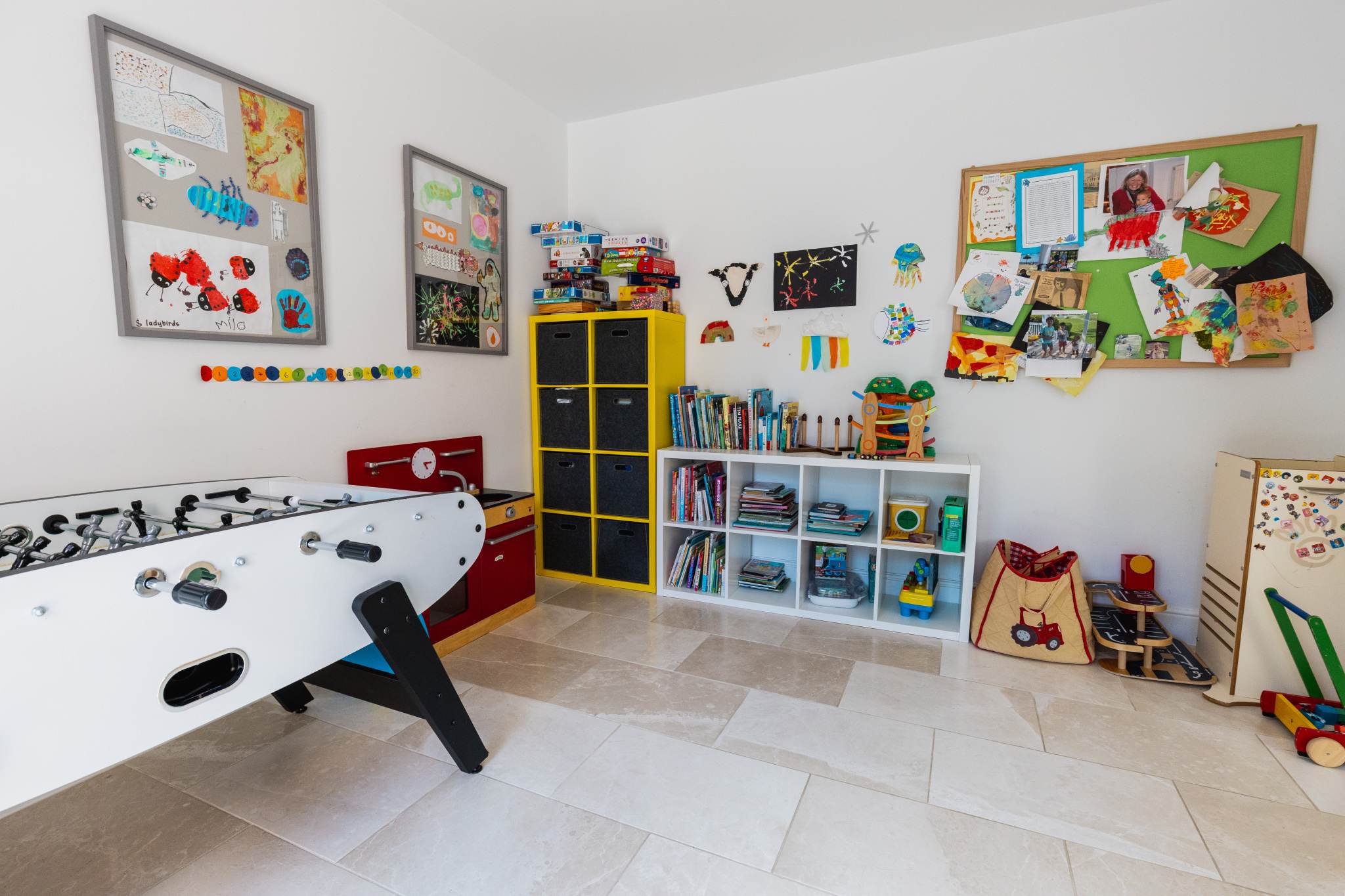 Spacious playroom with games, toys and organised storage, ideal for family stays and children’s activities.