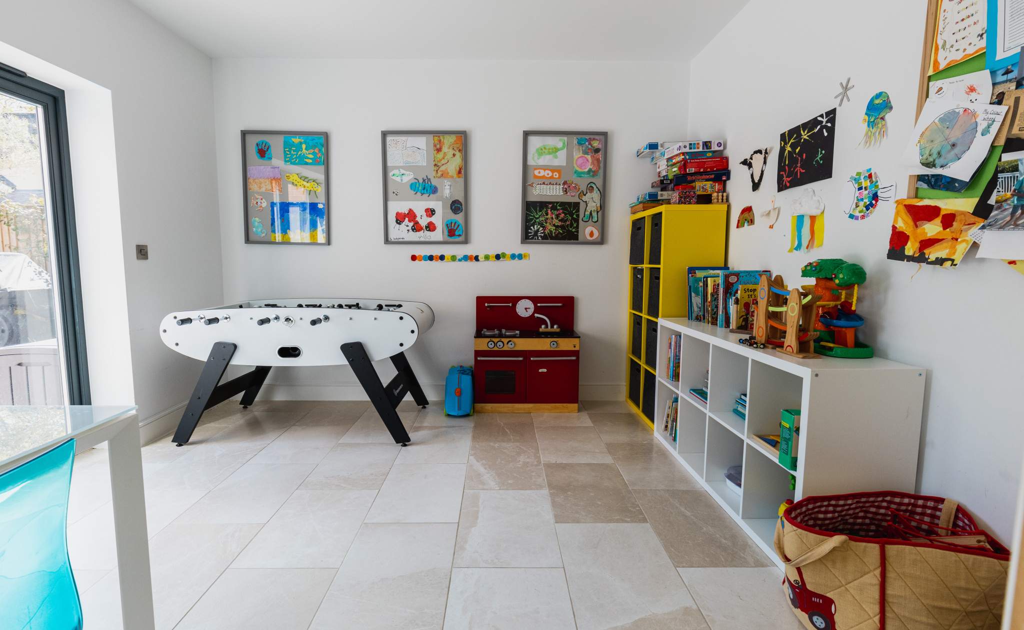 Family playroom with foosball table, toys and storage—perfect for keeping younger guests entertained.