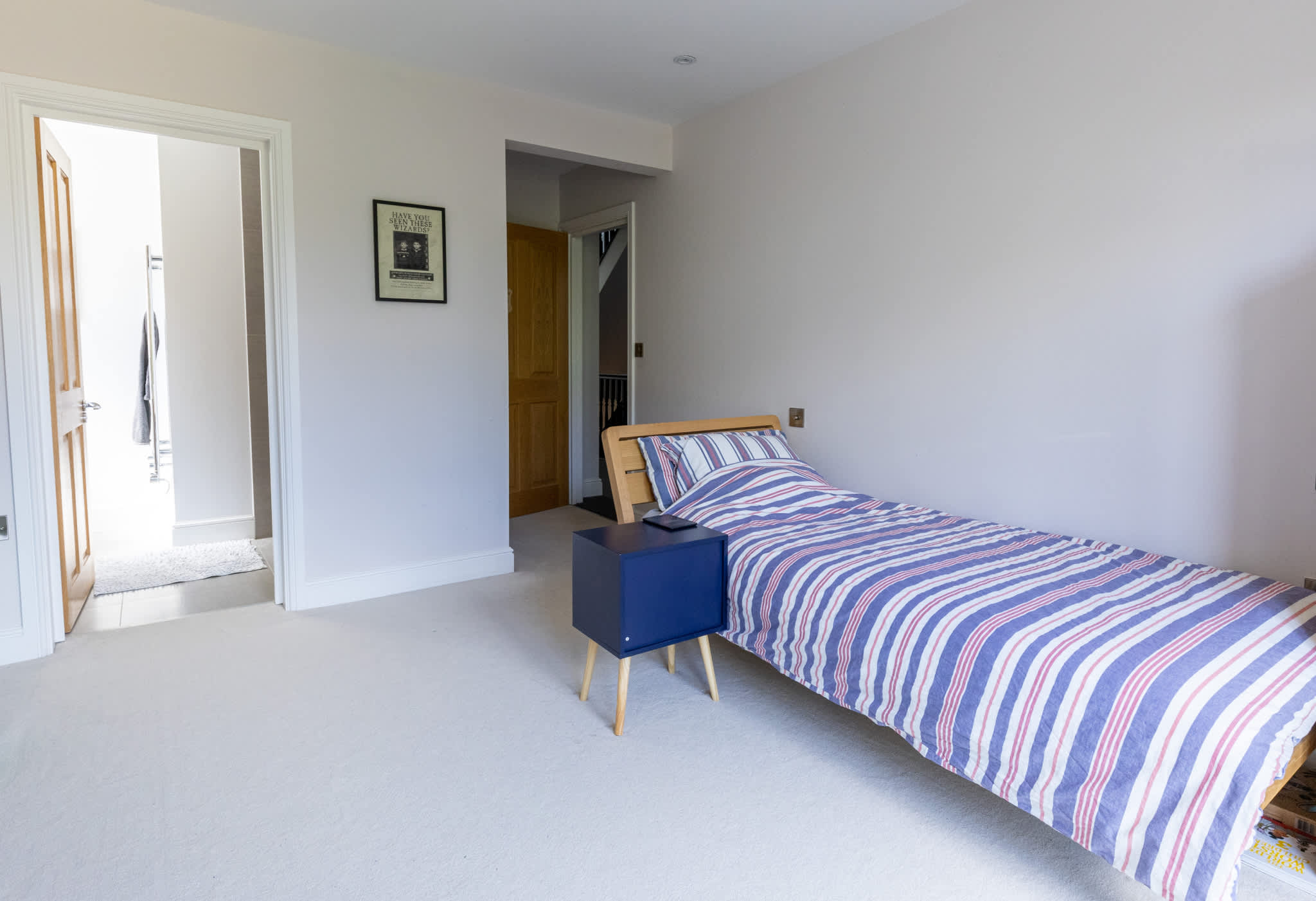 Spacious single bedroom with ensuite access, ideal for families or group stays.