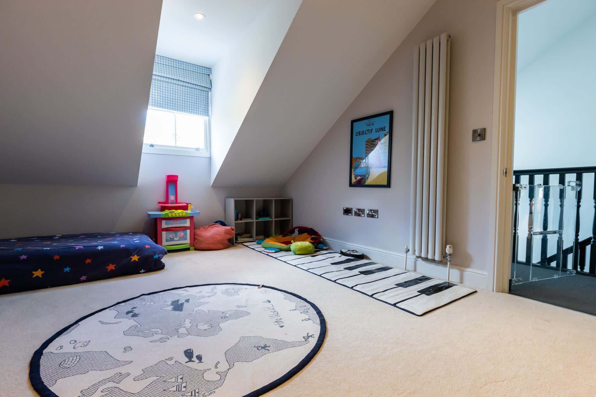Loft play area with soft seating, toys and skylight—perfect for relaxing or keeping younger guests entertained.