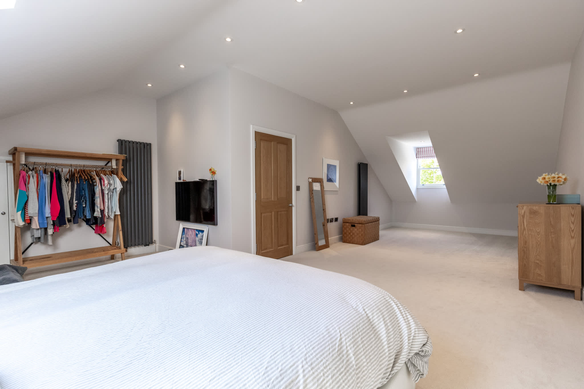 Large master bedroom with vaulted ceilings, skylight and generous floor space.