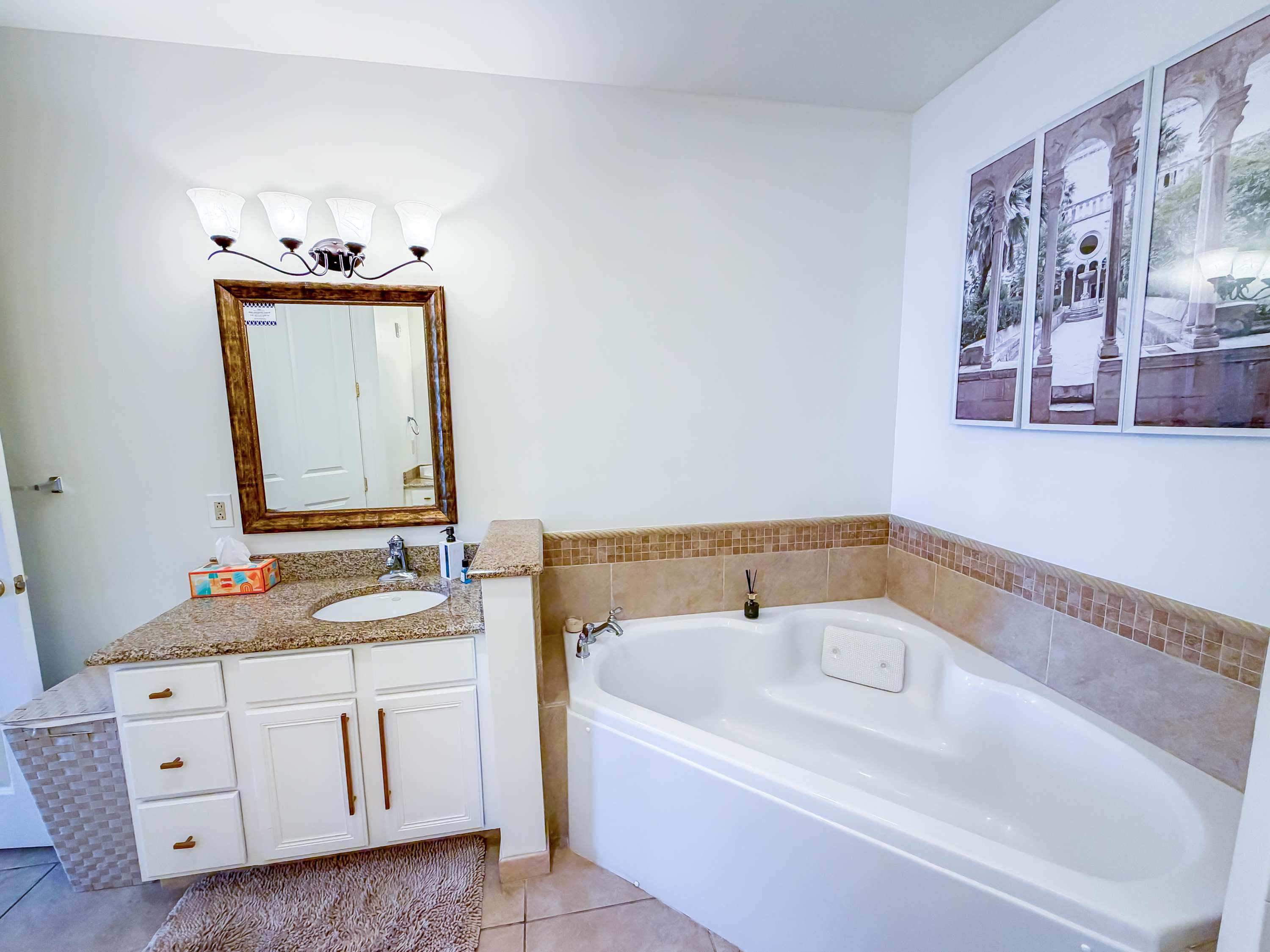 Marriott 3707 – Bathroom featuring a large jetted tub, granite countertop, and decorative wall art.