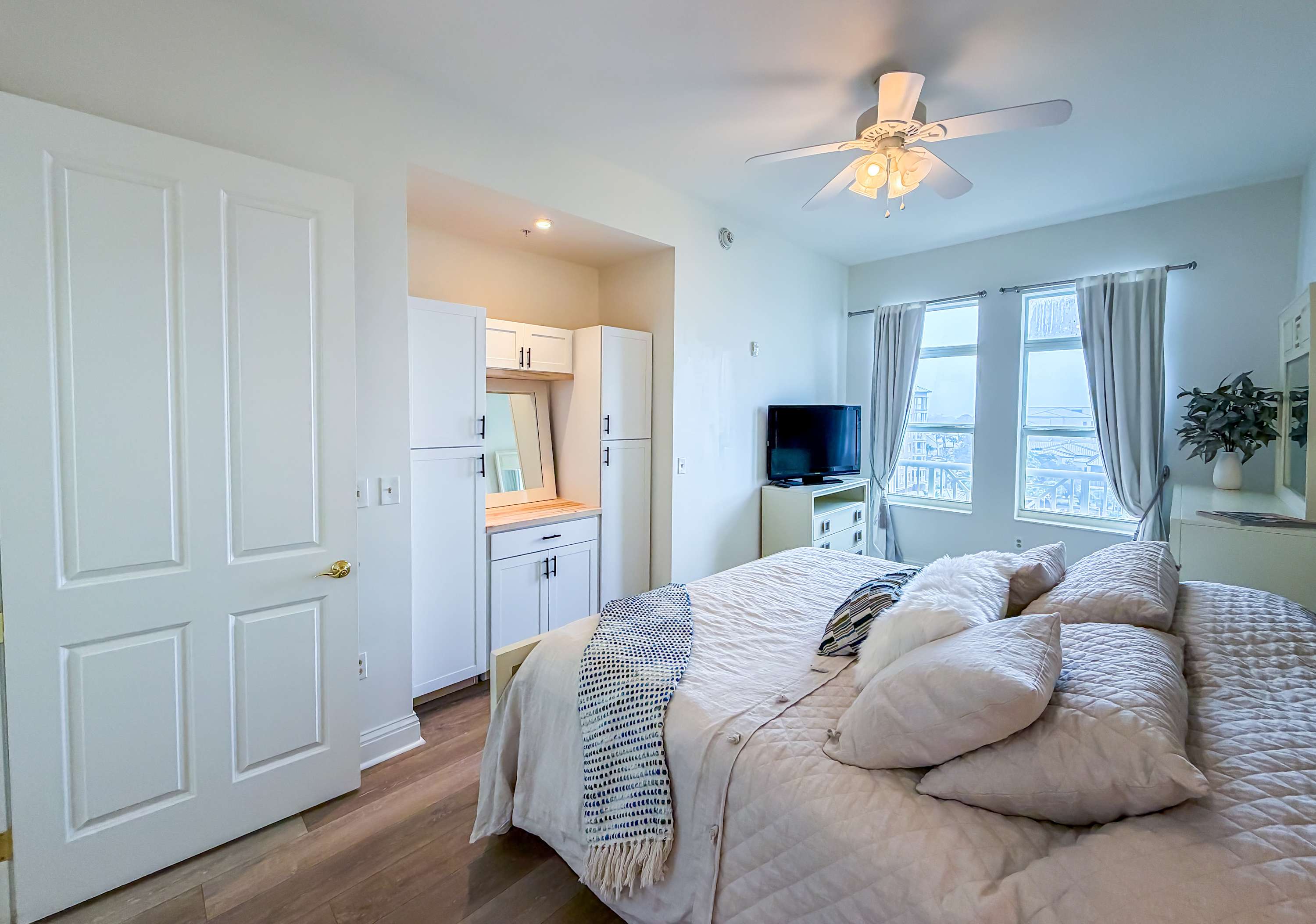 Marriott 3707 – Bright bedroom with a king-size bed, dresser, TV, and large windows offering scenic views.