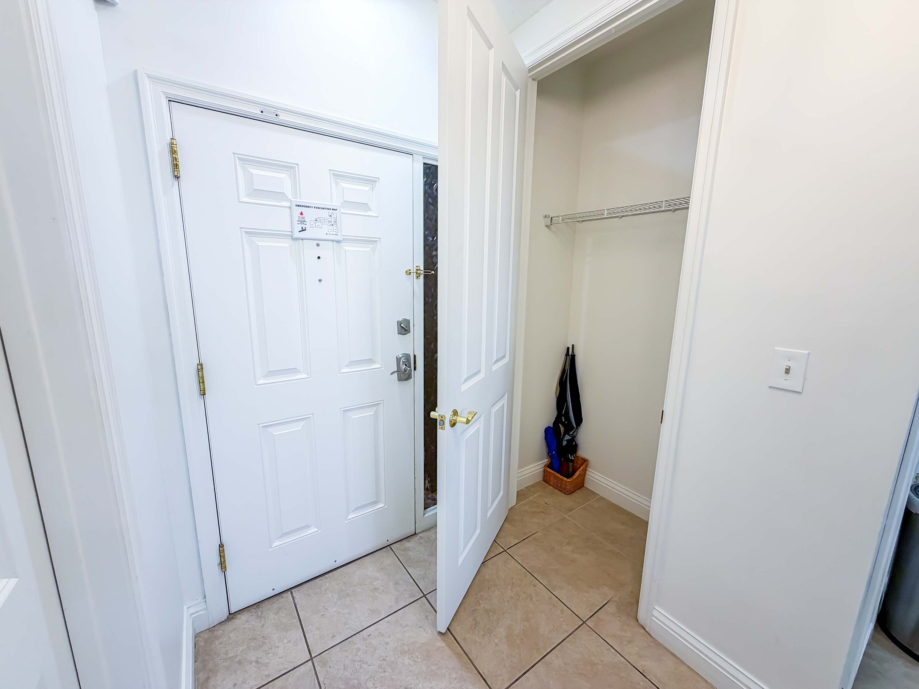 Marriott 3707 – Entrance hallway with a closed door, tile flooring, and a small closet for storage.