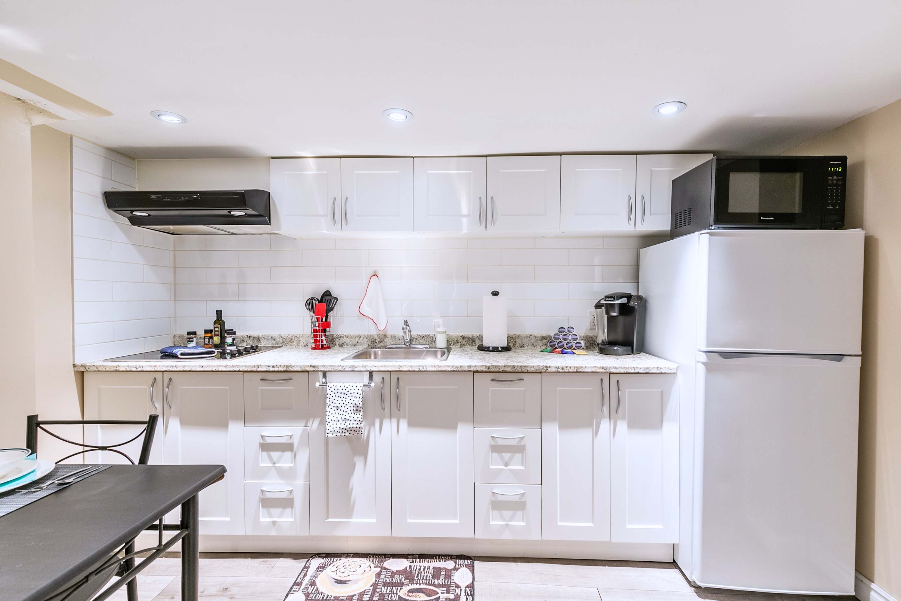 Fully equipped kitchen with stove, fridge, and appliances for convenient meal prep and cooking.