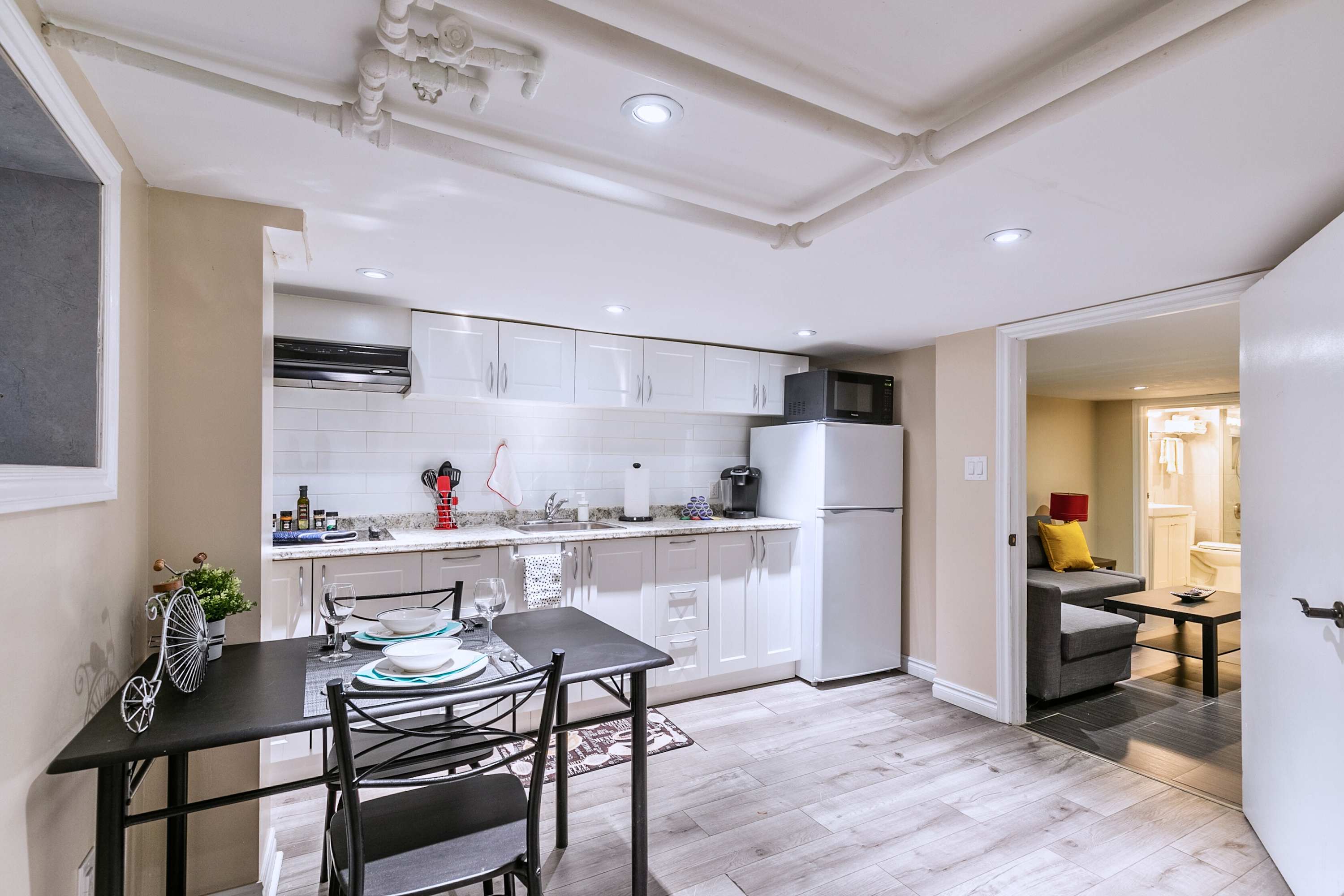 Spacious layout with dining table, full kitchen, and living room, ideal for meals and lounging.