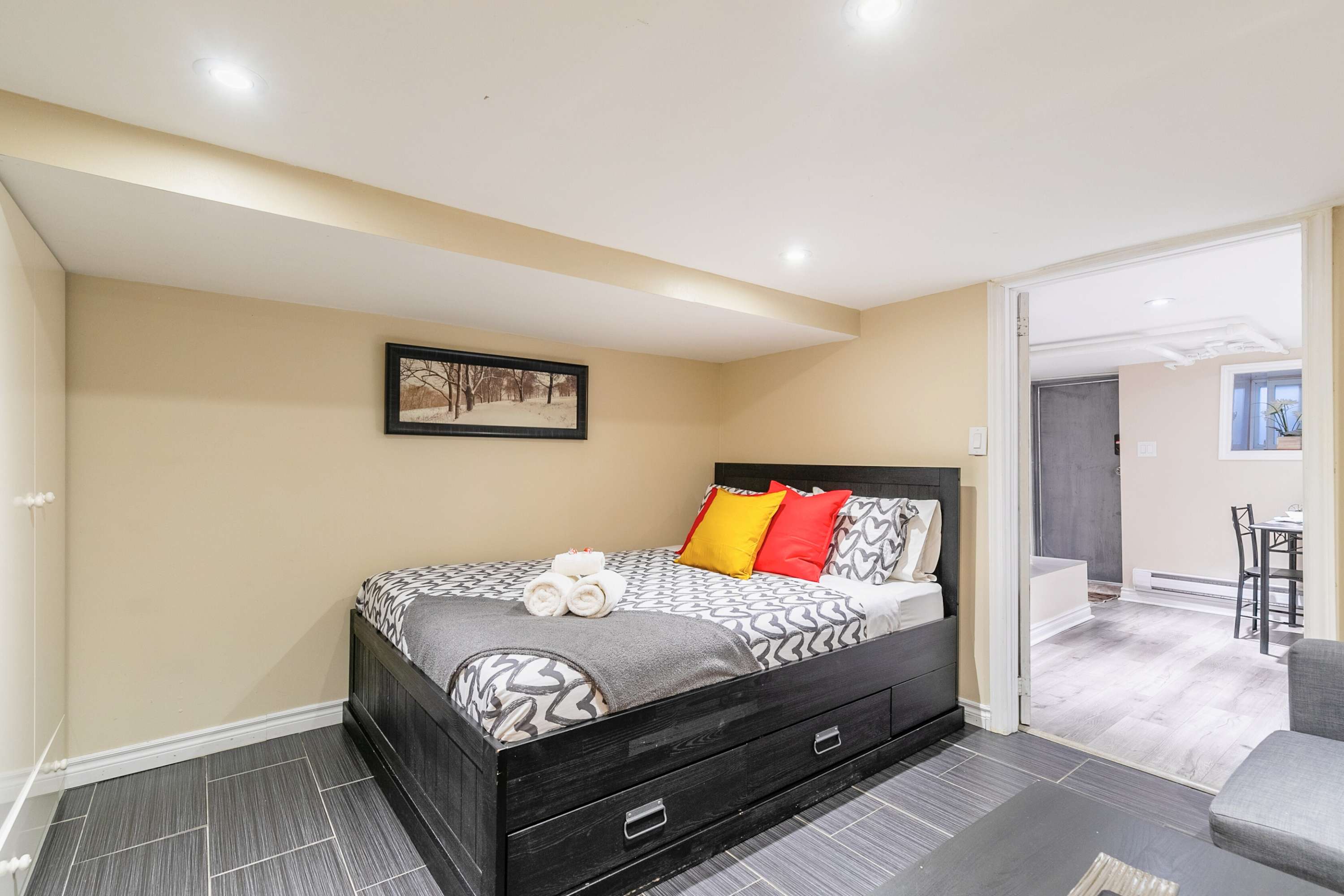 Bedroom with queen bed and direct access to the kitchen for easy movement and convenience.