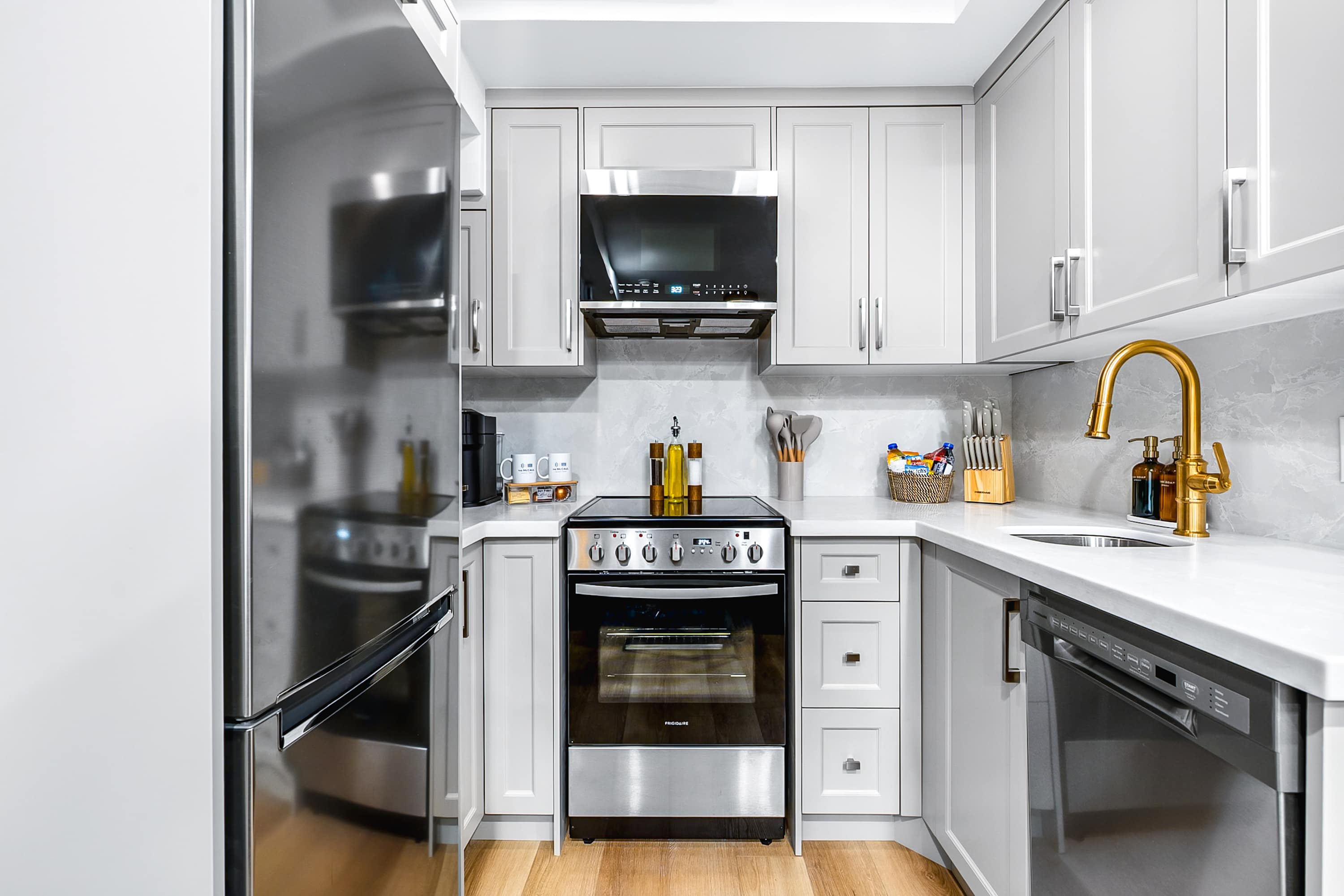 Fully equipped modern kitchen with stainless steel appliances.