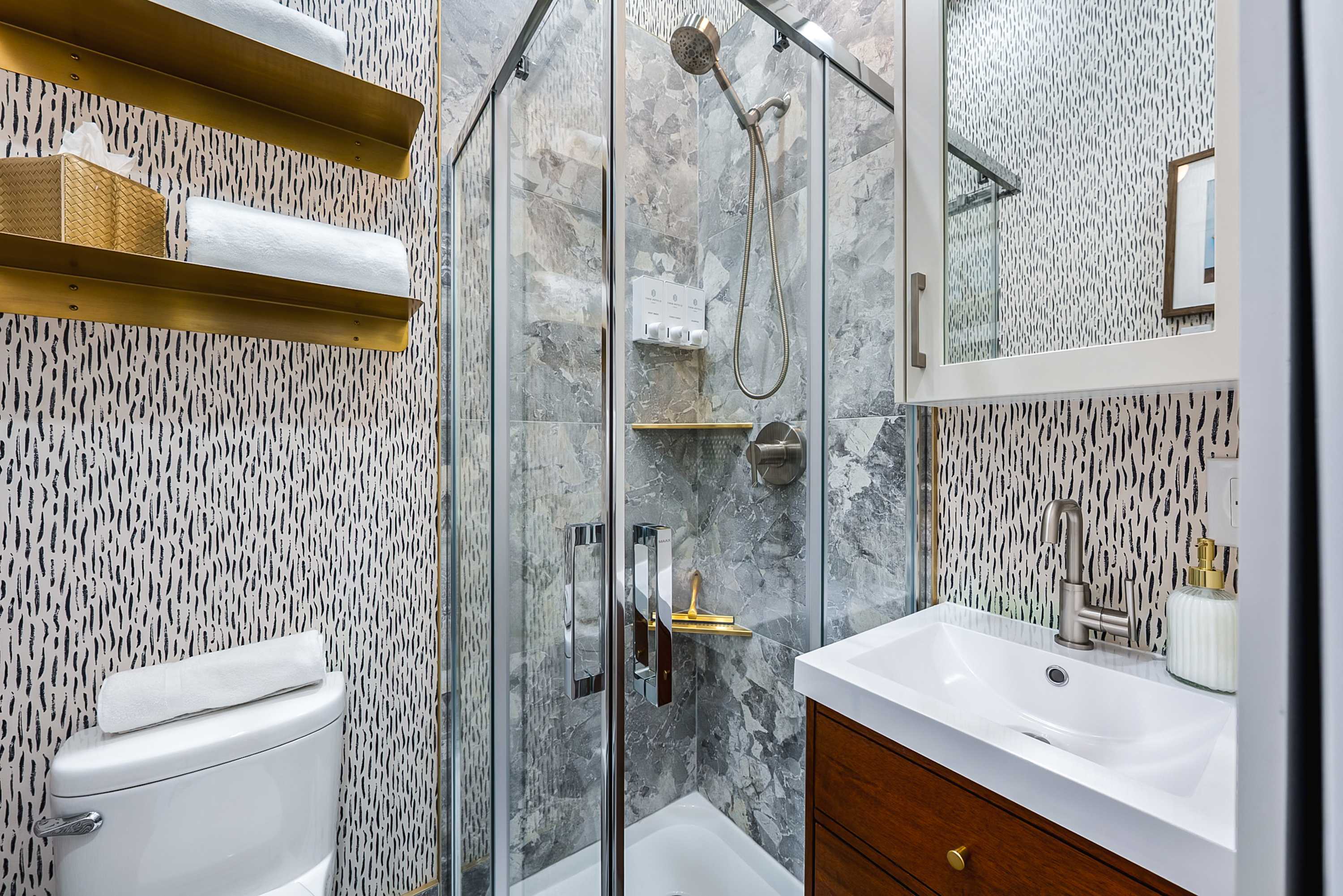 Fresh, modern bathroom with a walk-in glass shower.