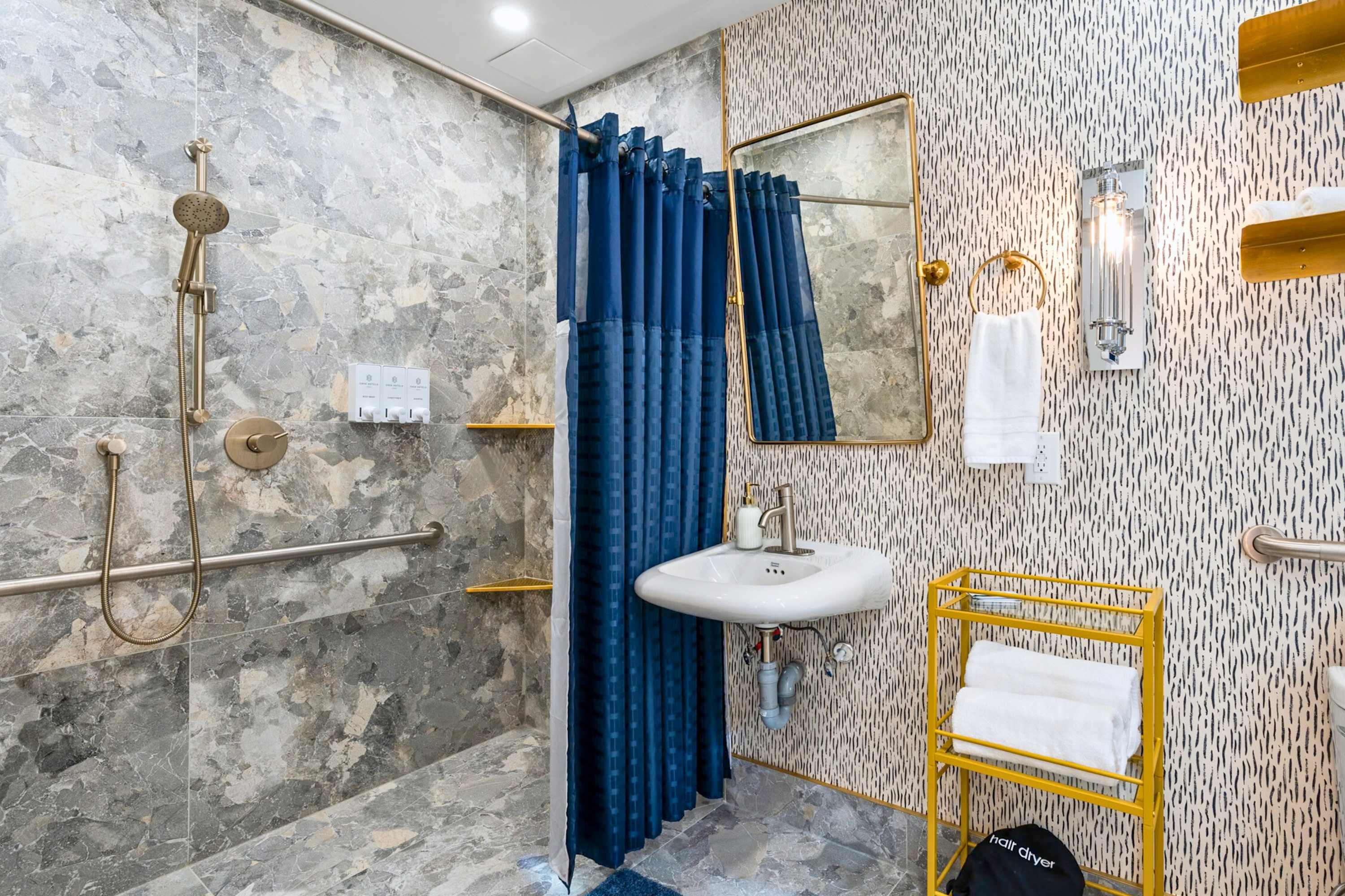 Modern bathroom vanity with fresh towels provided.