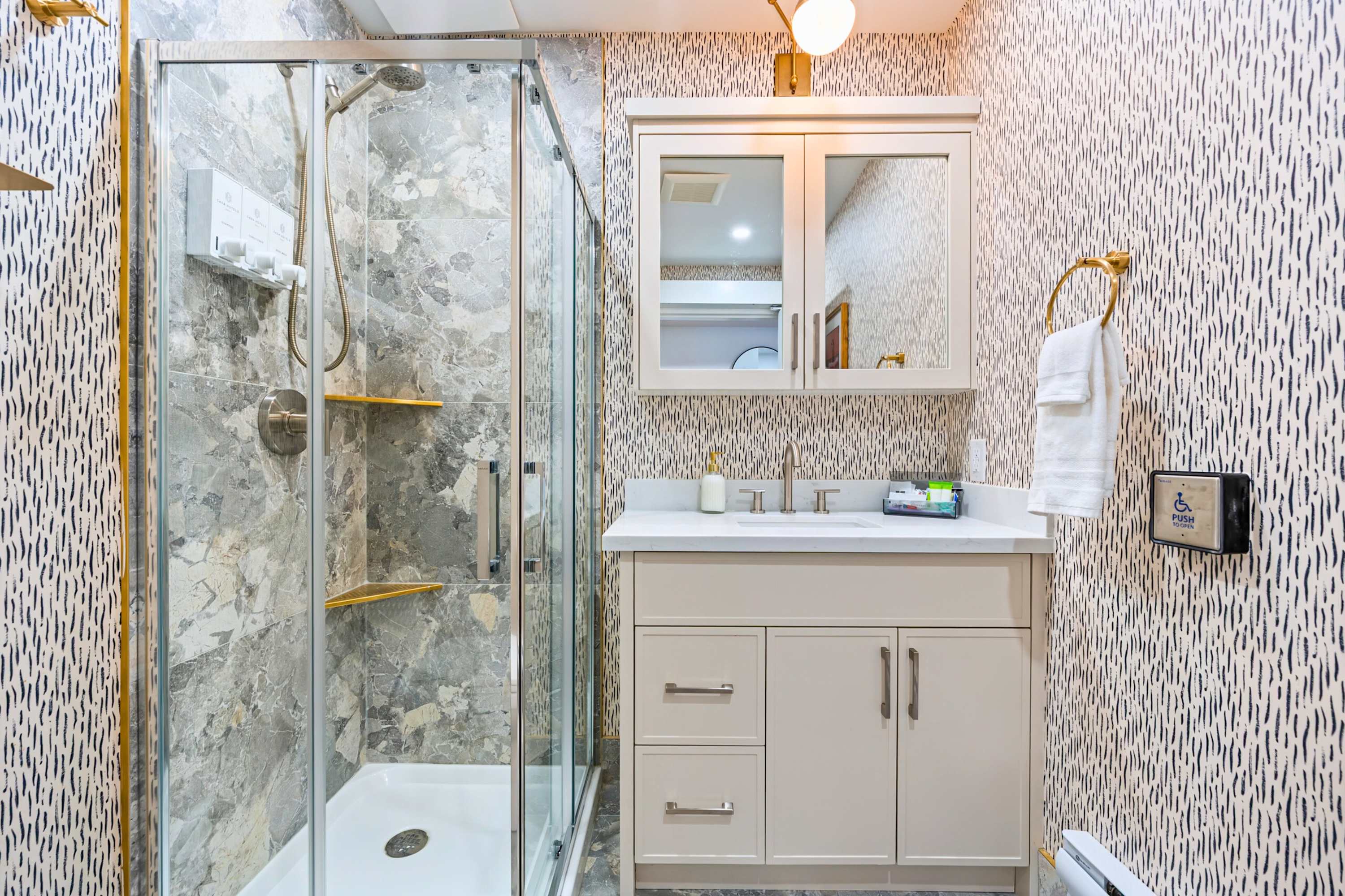 Modern bathroom with walk-in glass shower.