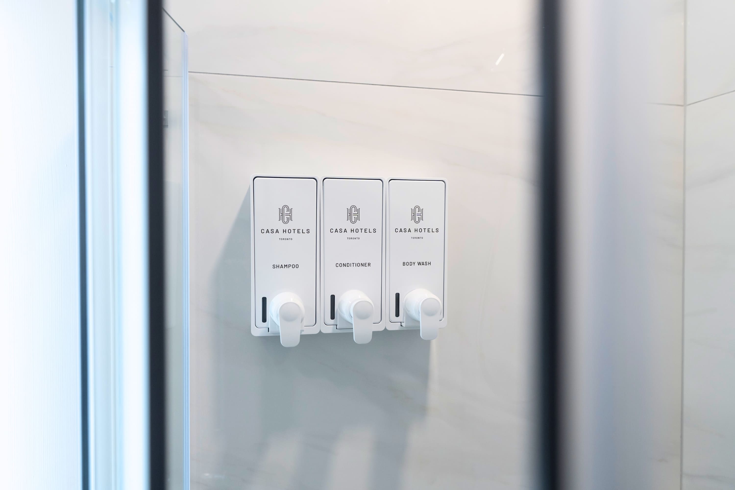 Triple wall-mounted shower dispenser.