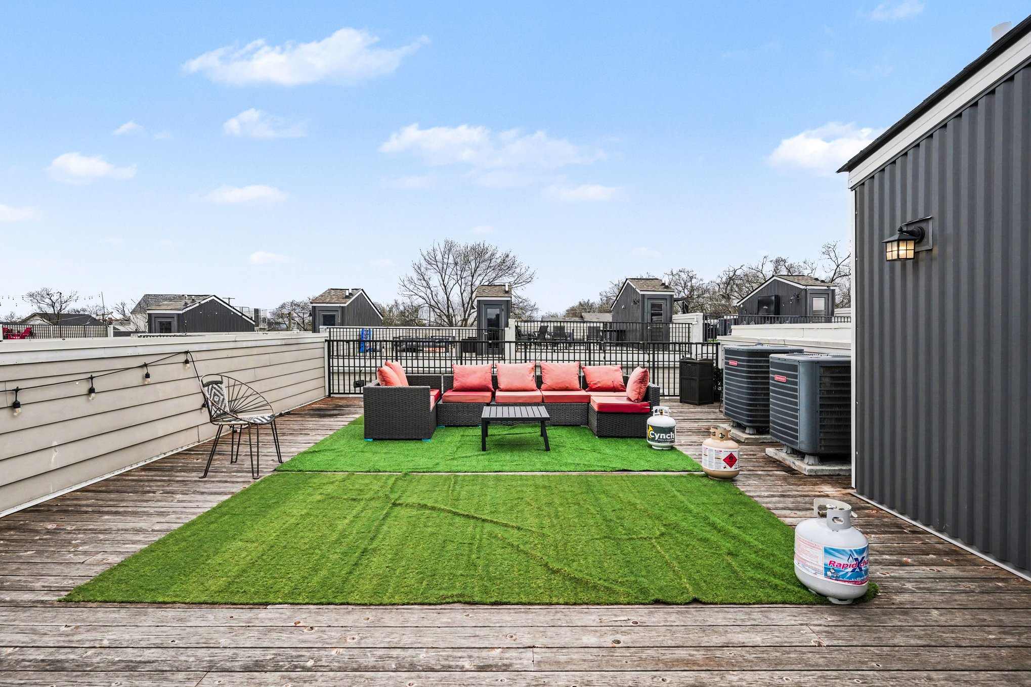 Rooftop patio with grill, corn hole, and views perfect for lounging.